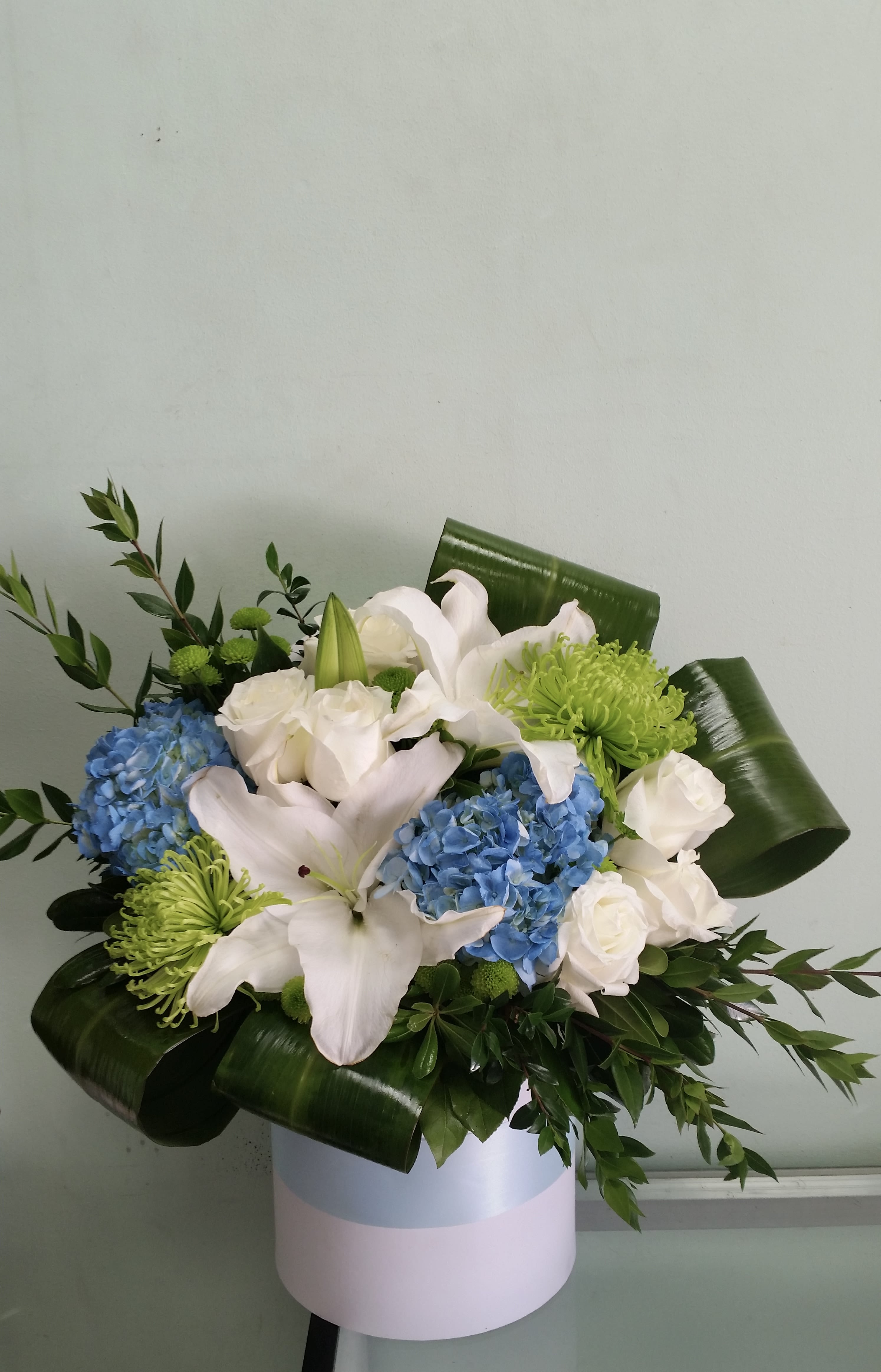 Spring Time Spring Time - Box arrangement with lilies, hydrangeas, roses, and mums.
