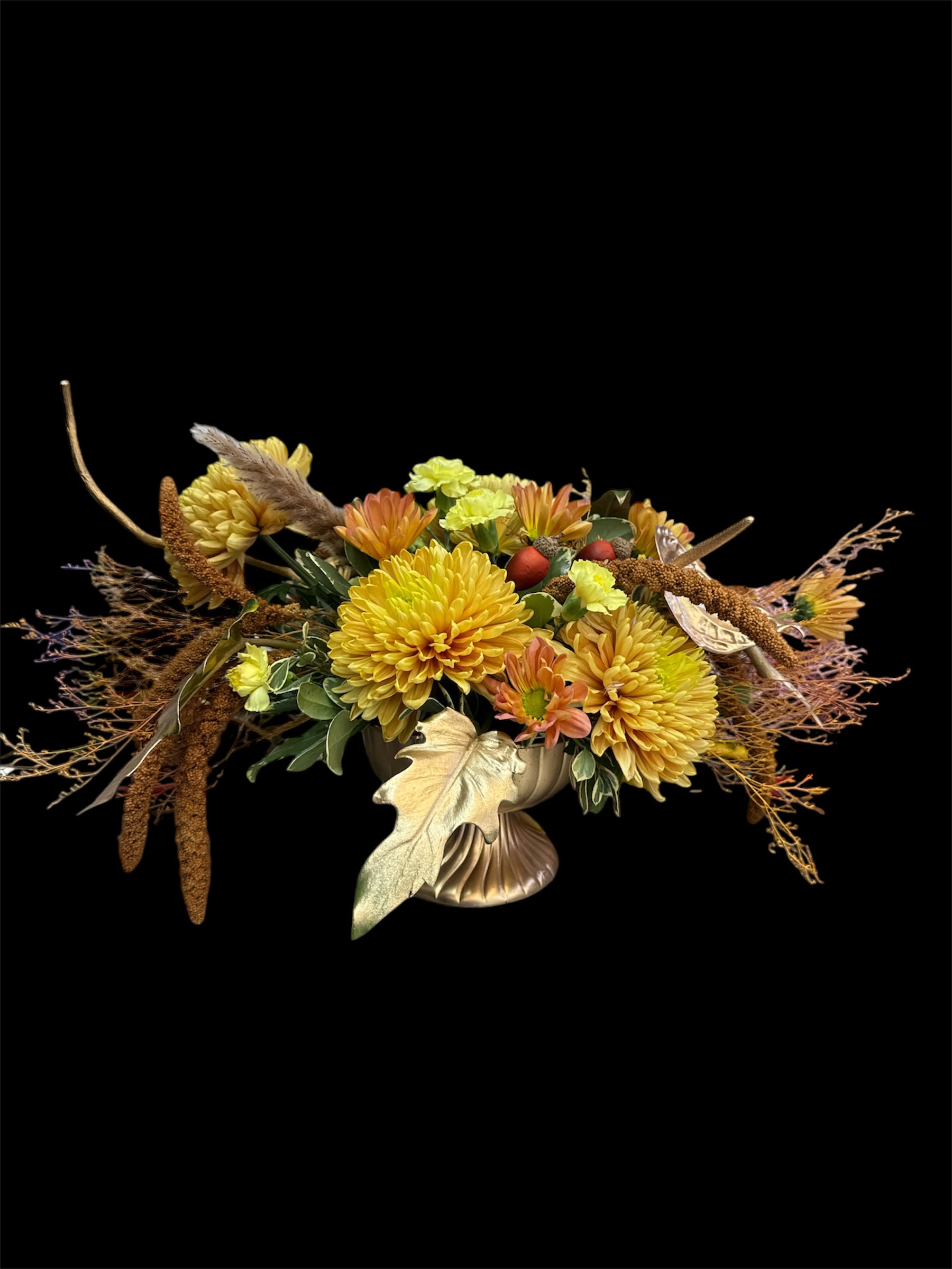 Goden set - Pedestal container  fill with golden chrysanthemum , brown daises, dry flowers and other touches that show this holiday season around the corner .