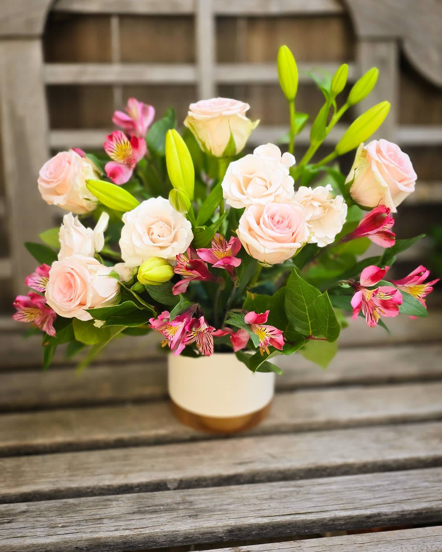 Pastel Party - This arrangement is delivered in a white ceramic and features soft pink and white florals! This versatile makes a wonderful gift when upgraded with one of our statement balloons.
