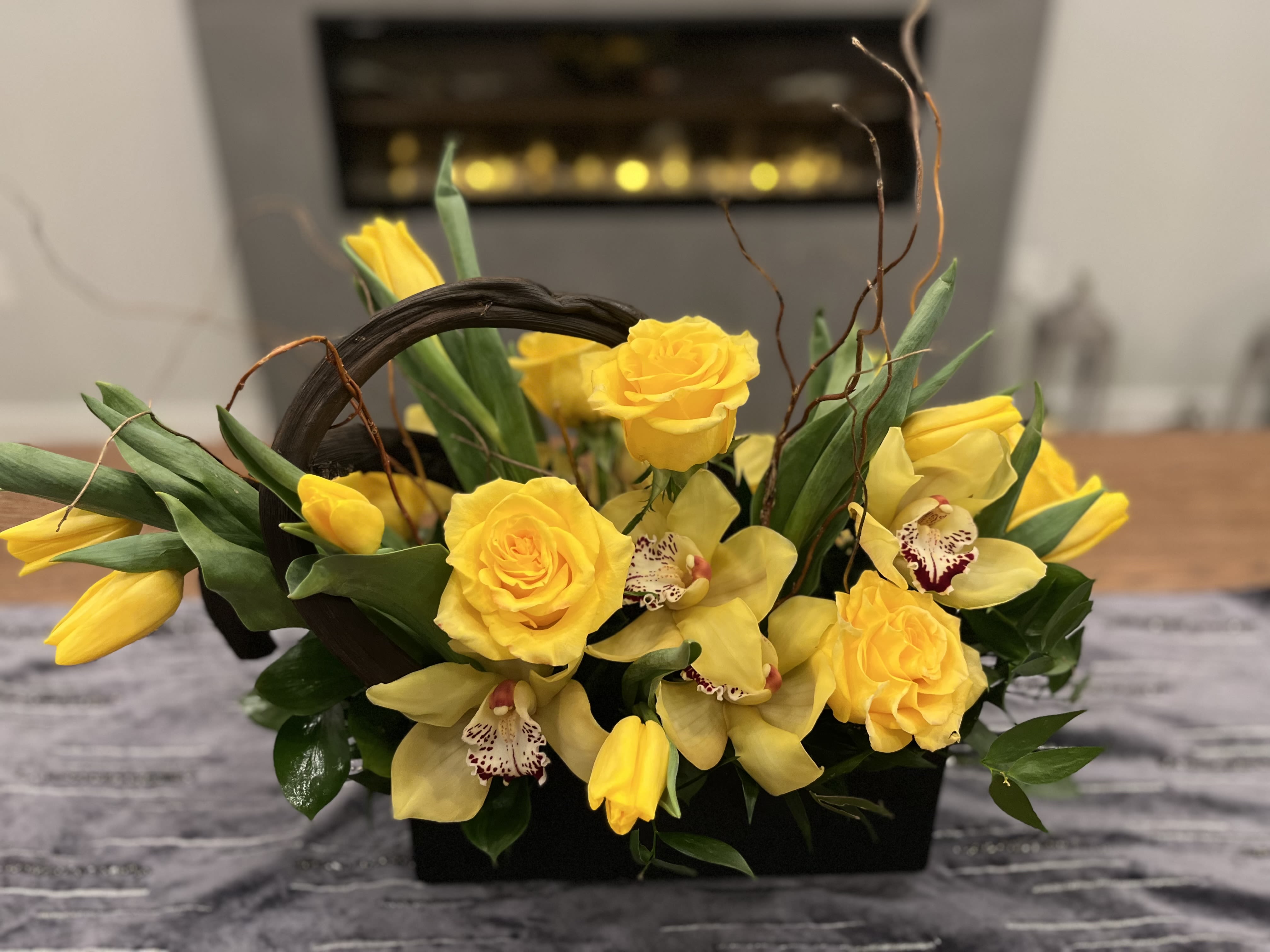Summer Roses - Our Summer Roses are a perfect gift for a friend or that special someone to let them know you are thinking of them.  Our Yellow Rose and Orchids are in a beautiful ceramic vase.