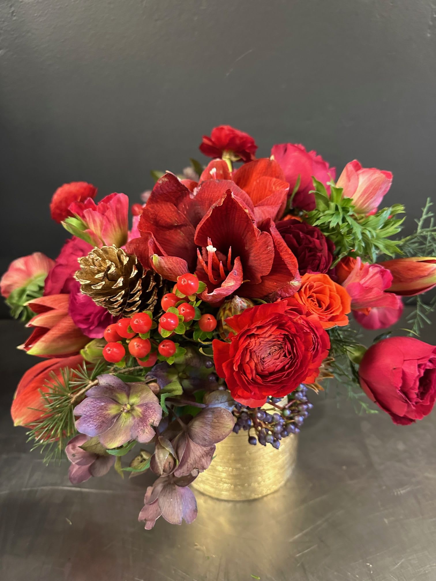 Better off Red - Better off Red says it all! Vibrant  shades of red with luxurious textures of ranunculus, amaryllis, anemones and a touch of holiday cheer. ***some of these stems may not be available and will be substituted appropriately. 