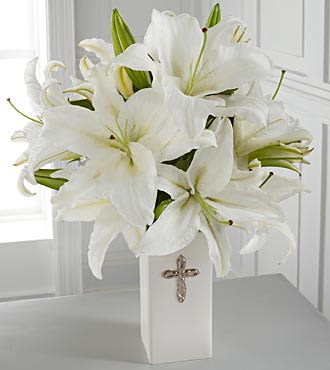 Faithful Blessing - The Faithful Blessings Bouquet is an incredible way to celebrate a communion, confirmation, or wedding, as well as send your sympathy for the loss of a loved one. Bringing together stems of fragrant Oriental Lilies, boasting multiple blooms on each stem to create a full and lush flower bouquet, this offering of flowers will bring peace and beauty to any of life's special moments and occasions. Presented in a keepsake designer white ceramic vase with a stunning cross on the front, this exquisite flower arrangement exudes heartfelt blessings with each eye–catching, star–shaped lily.