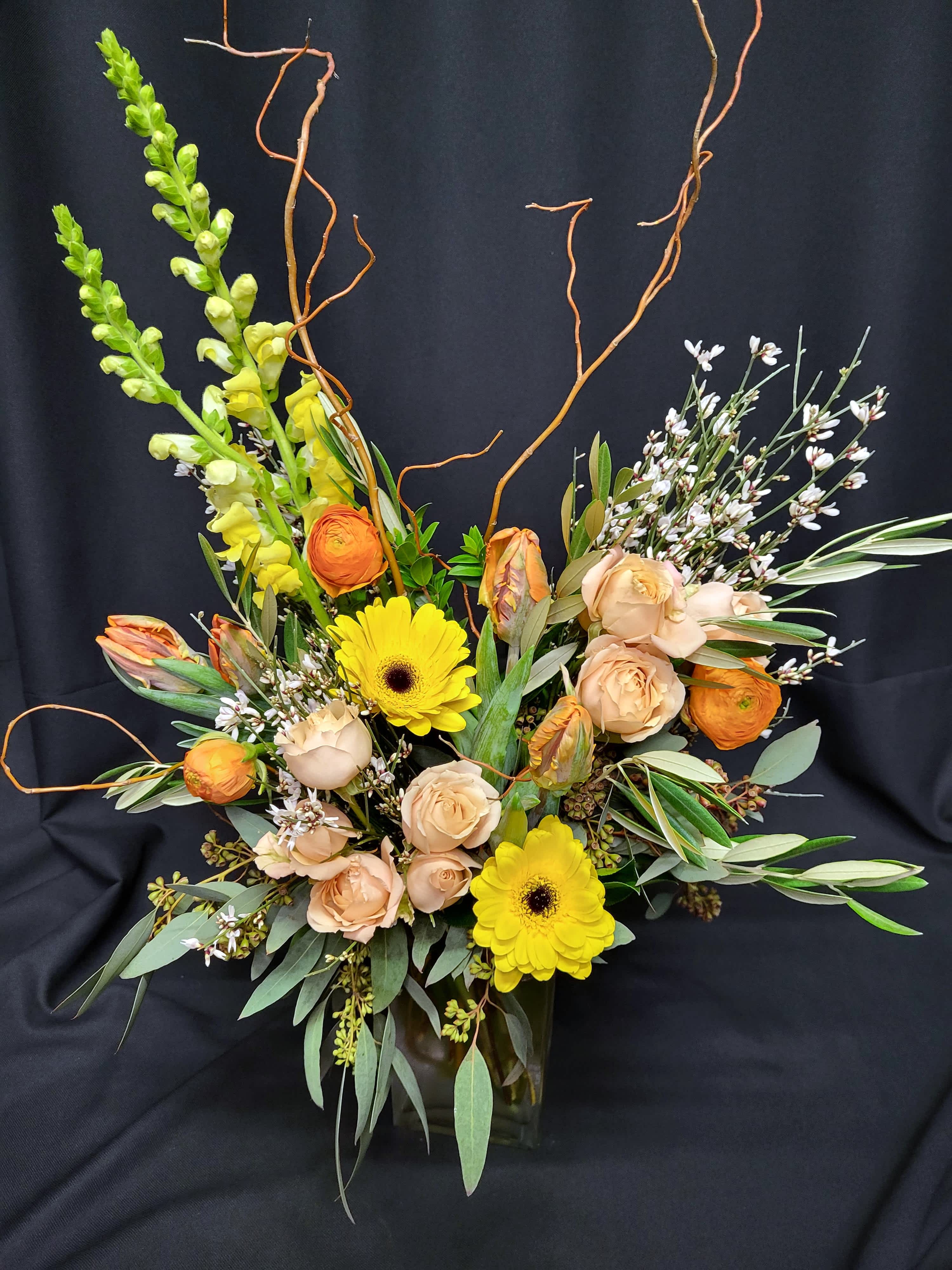 Peach parrot tulip cube with willow - Elegant rectangular glass vase of willow branches, coveted parrot tulips, ranunculus and premium flowers.  Please allow at Least a week's notice or be aware that many substitutions may be made, including colors and varieties.  Parrot tulips and ranunculus are best in winter and spring.  