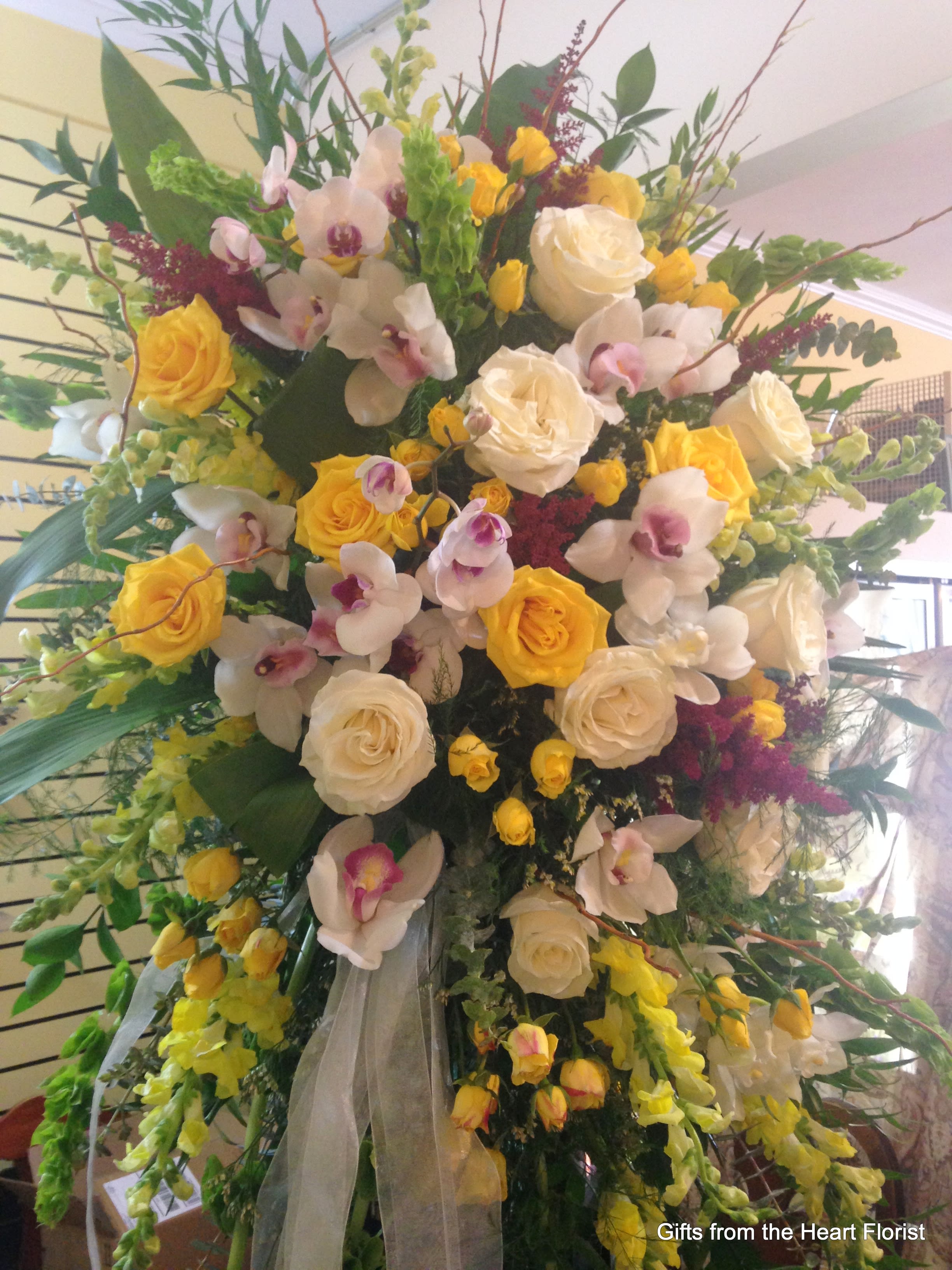Beautiful Garden Spray - This is an elegant upscale design of premium fine flowers.  Roses, garden roses, orchids, snap dragon  and stock.   PLEASE NOTE: All our funeral designs are custom made to your specifications when time allows.  The photo shown should be used as a guide to style.  