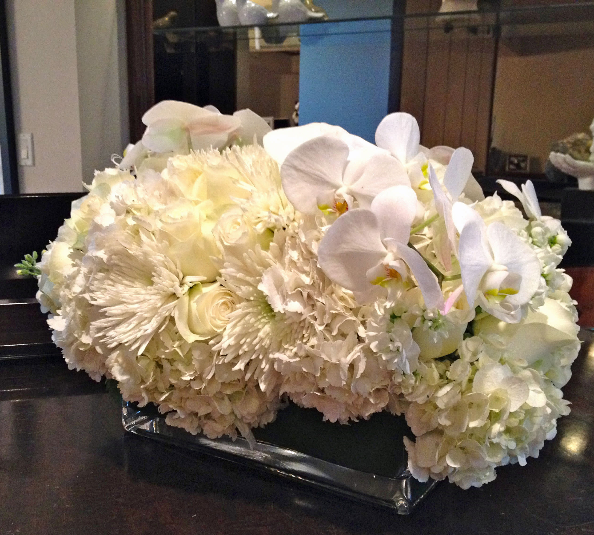 169 monochromatic multi rectagle - Monochromatic Fresh Floral Arrangement in Rectangular Vase from T'sul Custom Floral Design in Newport Beach, CA  Elevate your floral decor with our stunning monochromatic fresh floral arrangement, expertly designed and presented in a sleek rectangular vase, exclusively at T'sul Custom Floral Design in Newport Beach, CA. This striking arrangement showcases today’s market fresh finds, offering a harmonious blend of flowers in a single color palette that creates a sophisticated and modern look.  Perfect for any occasion, whether it’s a wedding, corporate event, or a stylish accent for your home, this rectangular vase arrangement brings elegance and beauty to any space. The cohesive color scheme enhances the visual impact, making it a centerpiece that captures attention and admiration.  Key Features:  Beautifully arranged in a contemporary rectangular vase Features a selection of fresh flowers in a monochromatic design Ideal for special events, home decor, or corporate settings Priced at $169 for a stunning display of quality and freshness Discover the elegance of a monochromatic fresh floral arrangement with T'sul Custom Floral Design in Newport Beach. Order yours today to bring a touch of sophistication to your space with exquisite blooms sourced from today’s market!      
