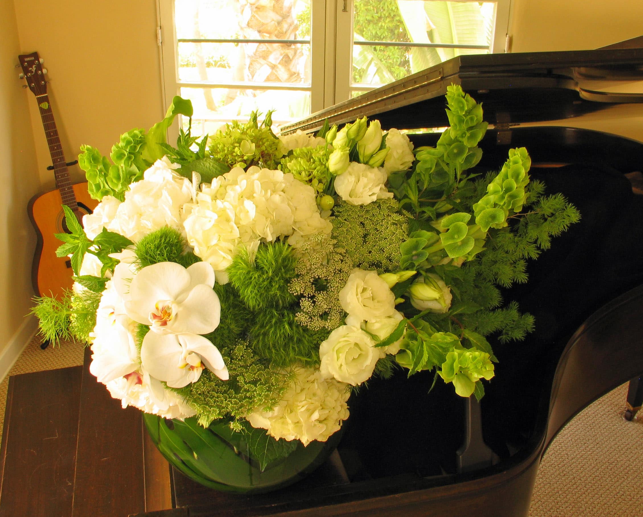 169 orchid fishbowl spray - Elegant White Floral Arrangement in Leaf-Lined Fish Bowl from T'sul Custom Floral Design in Newport Beach, CA  Enhance your decor with our stunning white floral arrangement, meticulously designed and beautifully presented in a leaf-lined 10-inch fish bowl, exclusively at T'sul Custom Floral Design in Newport Beach, CA. This exquisite arrangement features a delightful mix of white orchid blooms, hydrangea, fresh mint, Queen Anne's lace, lisianthus, Bells of Ireland, and tulips, creating a breathtaking centerpiece for any occasion.  Measuring approximately 25 inches wide and 22 inches tall, this elegant arrangement adds a touch of sophistication and freshness to your home, office, or special event. The combination of unique flowers provides a soft and romantic feel, making it an ideal choice for weddings, anniversaries, or as a thoughtful gift.  Key Features:  Beautifully arranged white flowers including orchids, hydrangea, tulips, and more Presented in a stylish leaf-lined 10-inch fish bowl Finished size of approximately 25&quot; wide and 22&quot; tall for a stunning display Perfect for home decor, weddings, and other special occasions Transform your Newport Beach space with T'sul Custom Floral Design's elegant white floral arrangement in a leaf-lined fish bowl. Order today to enjoy the beauty of fresh, exquisite blooms delivered directly to your door!