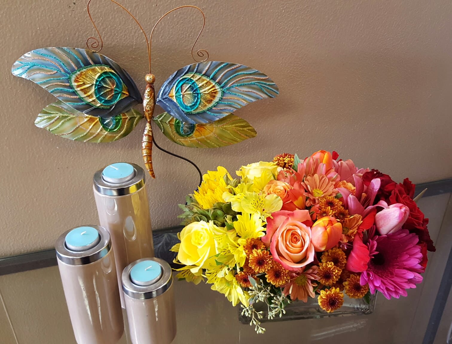 OMBRE SHERBET OMBRE SHERBET - A GORGEOUS OMBRE SHERBERT FADE OF FLOWERS. BEAUTIFUL ROSES, GERBERAS, AND TULIPS; MIXED WITH LONG LASTING ALSTROMERIA, BUTTON MUMS, AND DAISIES HOUSE IN A LUSH BED OF GREENS