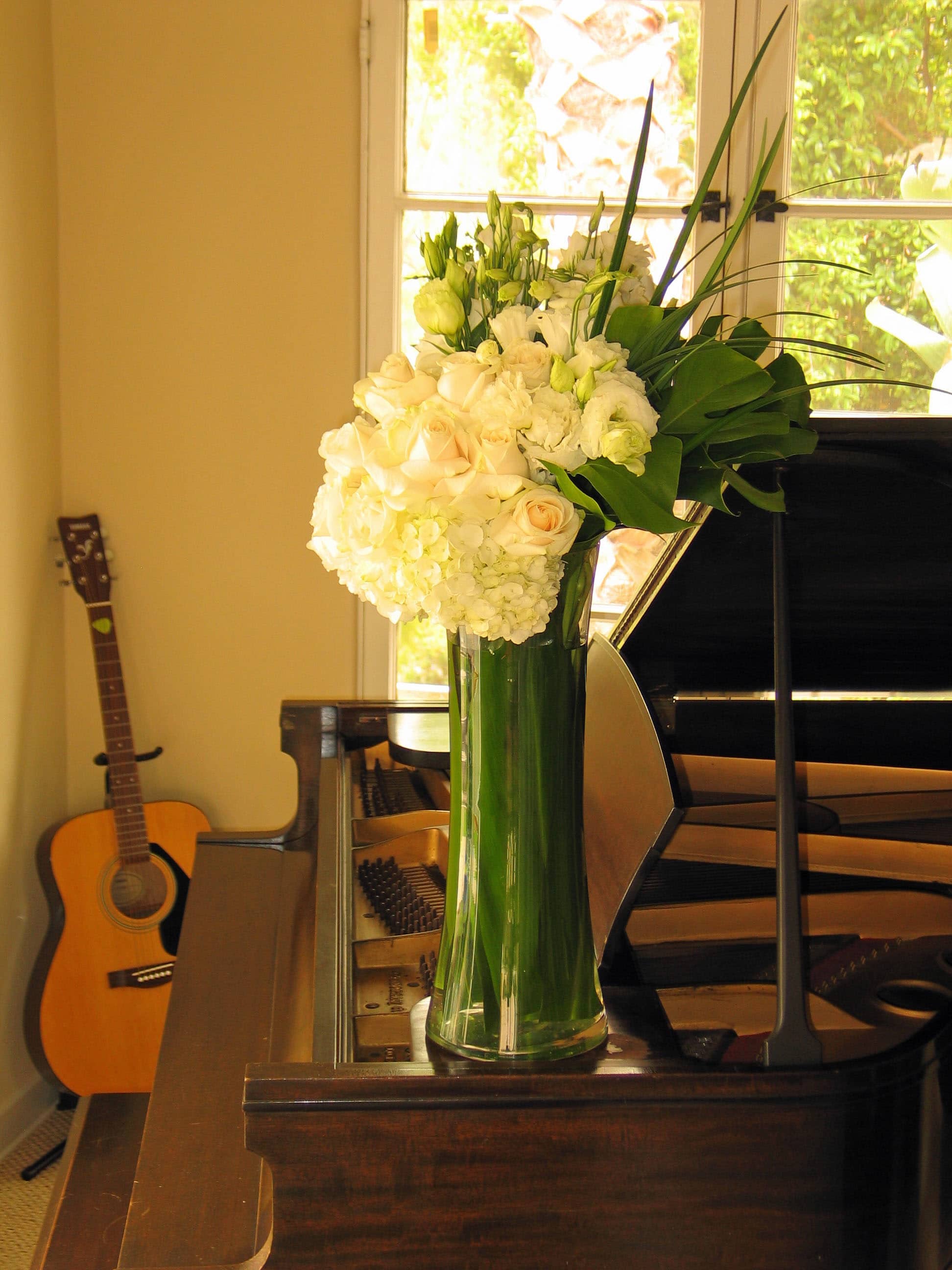 189 Tall cylinder - Tall Cylinder Floral Arrangement with a Mixture of Fresh Flowers from T'sul Custom Floral Design in Newport Beach, CA  Brighten up your space with our stunning Tall Cylinder Floral Arrangement, expertly designed with a delightful mixture of fresh flowers, exclusively from T'sul Custom Floral Design in Newport Beach, CA. This elegant arrangement features a vibrant selection of seasonal blooms, carefully curated to create an eye-catching centerpiece that adds sophistication and charm to any environment.  Perfect for home decor, office spaces, or special events, our tall cylinder arrangement is a versatile choice that brings beauty and freshness to any setting. Each flower is selected for its quality and color, ensuring a long-lasting display that will impress your guests and elevate your decor.  Key Features:  Elegant tall cylinder filled with a mixed selection of premium fresh flowers Ideal for dining tables, entryways, or as a standout gift for loved ones Crafted with locally sourced blooms for exceptional quality and freshness Customizable options available to match your color preferences and style Transform your Newport Beach home or event with T'sul Custom Floral Design’s beautiful Tall Cylinder Floral Arrangement. Order today to enjoy the vibrant beauty of fresh flowers delivered right to your door!