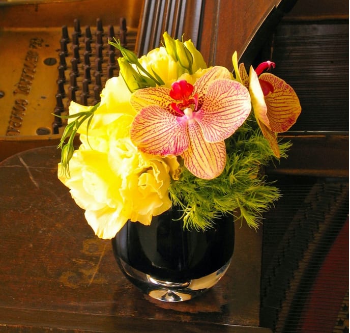 59 Desk Top - Petite Desktop Vase Arrangement with Orchids and Fresh Flowers from T'sul Custom Floral Design in Newport Beach, CA  Elevate your workspace with our charming Petite Desktop Vase Arrangement, featuring exquisite orchids paired with a selection of fresh seasonal flowers. Exclusively designed by T'sul Custom Floral Design in Newport Beach, CA, this delightful arrangement is perfect for adding a touch of elegance to your office or home desk.  Designed to brighten up any space, this petite vase is filled with beautiful blooms that create a vibrant and inviting atmosphere. The combination of delicate orchids and other fresh flowers makes this arrangement an ideal gift for colleagues, friends, or yourself!  Key Features:  Compact and stylish vase ideal for desktop decor Features a mix of stunning orchids and fresh seasonal flowers Perfect for home offices, corporate settings, or as a thoughtful gift Locally sourced for the highest quality and durability Transform your Newport Beach workspace with T'sul Custom Floral Design’s lovely Petite Desktop Vase Arrangement. Order today to bring the beauty of fresh flowers into your daily routine! 