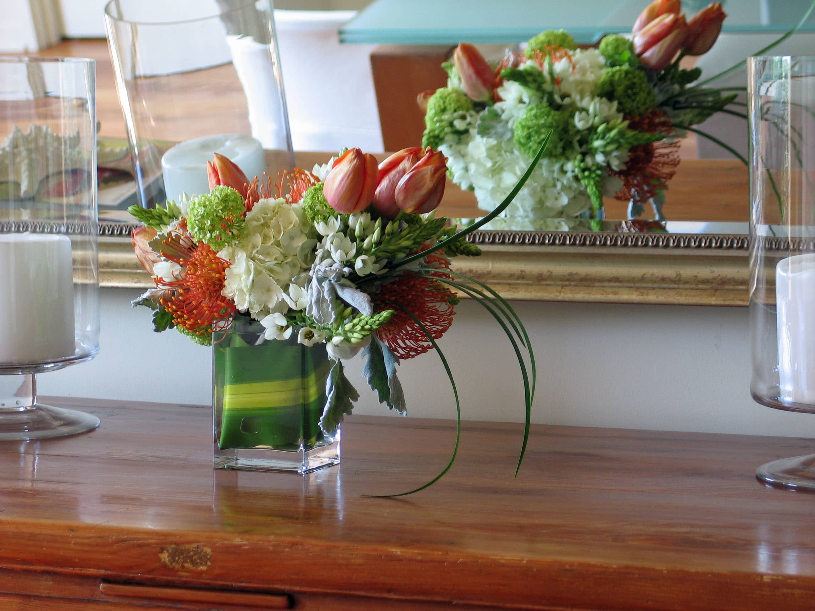59 Multi-spray rectagle -  Fresh Floral Arrangement in Tall Square Vase from T'sul Custom Floral Design in Newport Beach, CA  Transform your table with our stunning arrangement of today’s freshest flowers, elegantly presented in a tall square vase, exclusively from T'sul Custom Floral Design in Newport Beach, CA. This eye-catching floral display features a vibrant mix of seasonal blooms that are sure to elevate your dining or living space.  Perfect for enhancing your home decor or adding a touch of elegance to special occasions, this tall square vase arrangement is designed to create a striking centerpiece that captures attention and admiration. Each flower is carefully selected for its freshness and beauty, ensuring a long-lasting and delightful presentation.  Key Features:  Beautifully arranged with a variety of fresh, seasonal flowers Tall square vase design perfect for dining tables, coffee tables, or events Ideal for home decoration, special celebrations, or as a thoughtful gift Crafted with high-quality blooms for lasting beauty and fragrance Bring the beauty of fresh flowers into your Newport Beach home with T'sul Custom Floral Design’s exquisite arrangement in a tall square vase. Order today to enjoy a vibrant centerpiece that brightens any table!