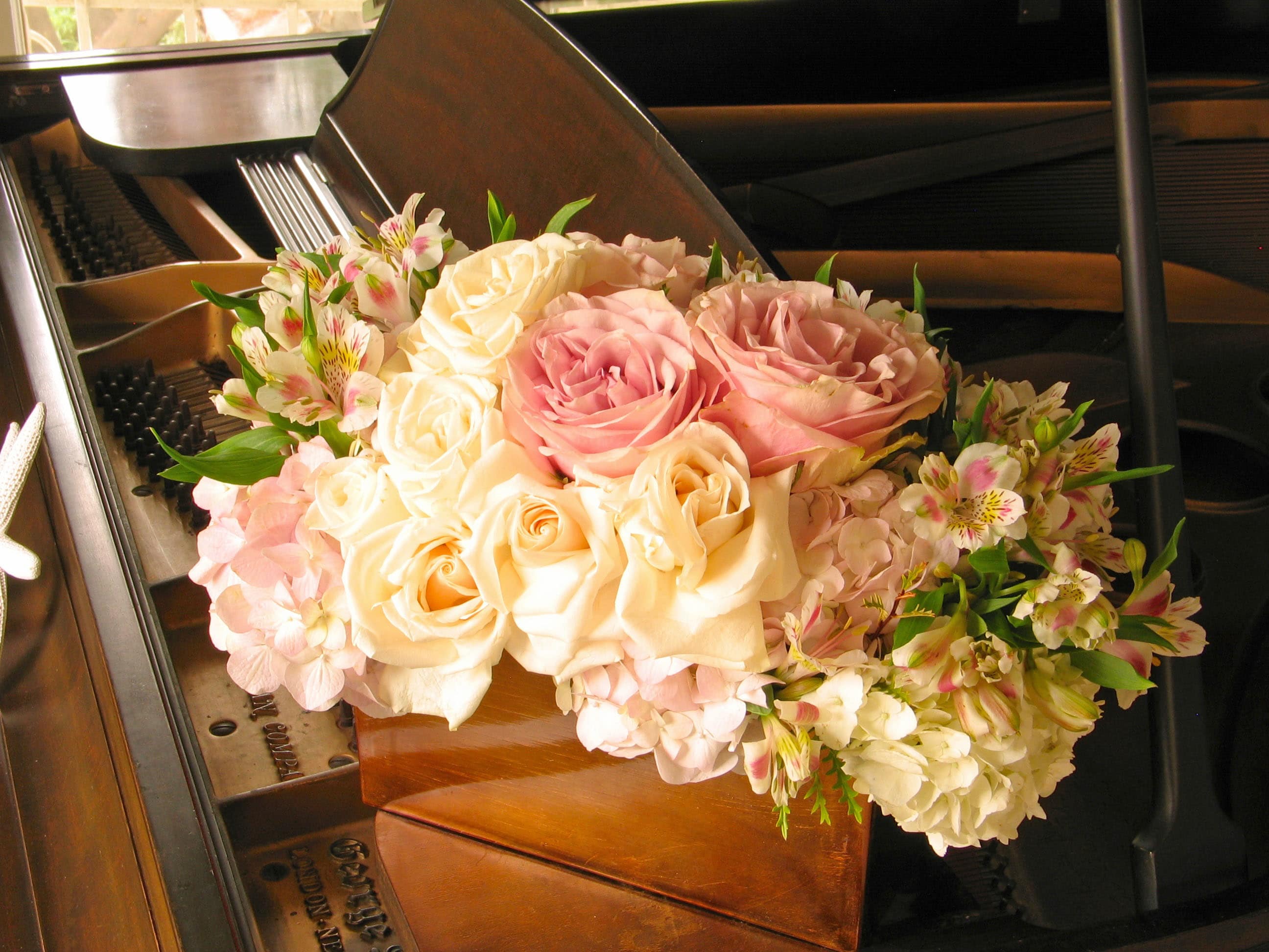 Multifloral rectangle with romantic blooms - Stunning Floral Arrangement with Dozen Roses in Rectangular Vessel from T'sul Custom Floral Design in Newport Beach, CA  Discover the beauty of our exquisite floral arrangement, filled with at least a dozen premium roses and overflowing with a delightful variety of other blooms, elegantly presented in a stylish rectangular vessel. Exclusively crafted by T'sul Custom Floral Design in Newport Beach, CA, this stunning arrangement is perfect for brightening any space, whether at home, in the office, or for special occasions.  Available Options: Deluxe Arrangement: For an even more impressive display, choose our Deluxe option filled with two dozen roses alongside a generous selection of complementary blooms. Please note, if a specific rose color is not specified at the time of order, we will use beautiful cream-colored roses for a timeless, elegant look.  Key Features:  Gorgeous arrangement featuring at least a dozen premium roses and a mix of fresh blooms Presented in a contemporary rectangular vessel for an elegant touch Ideal for home decor, weddings, corporate events, or as a thoughtful gift Crafted with fresh, high-quality flowers to ensure lasting beauty and fragrance Transform your Newport Beach environment with T'sul Custom Floral Design's stunning rose arrangement in a rectangular vessel. Order today to bring the enchanting beauty of fresh flowers into your life!