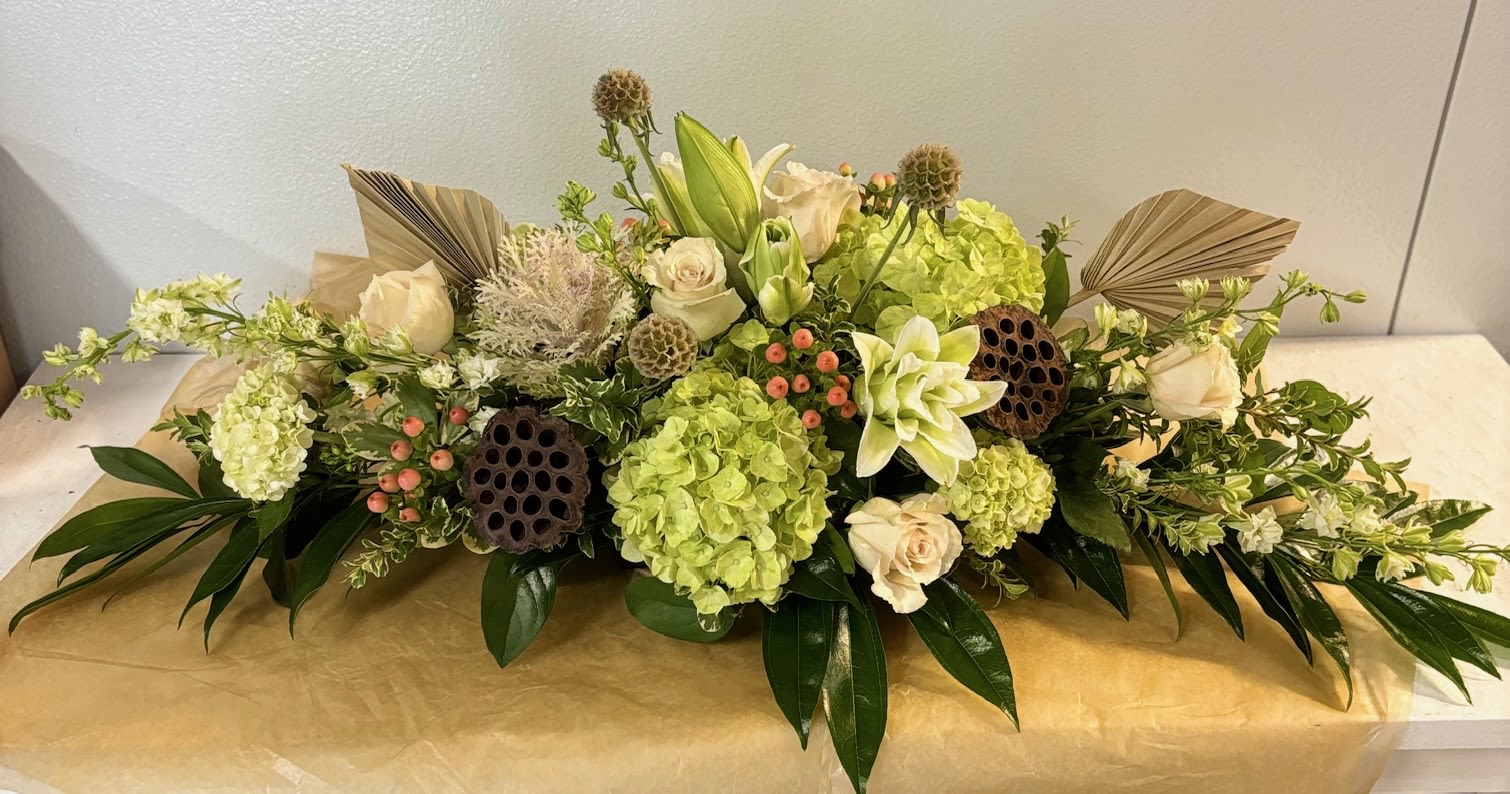 Neutral Elegance Neutral Elegance - Elegant long and low centerpiece with hydrangea, lilies, kale, roses, hypericum berries and scabiosa with hints of autumn.