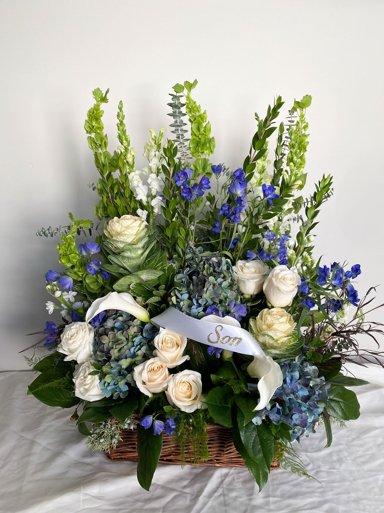 Sympathy Traditions Basket - Perfect for commemorations, this arrangement offers a heartfelt way to celebrate a life well-lived while bringing a touch of natural grace to any memorial setting.