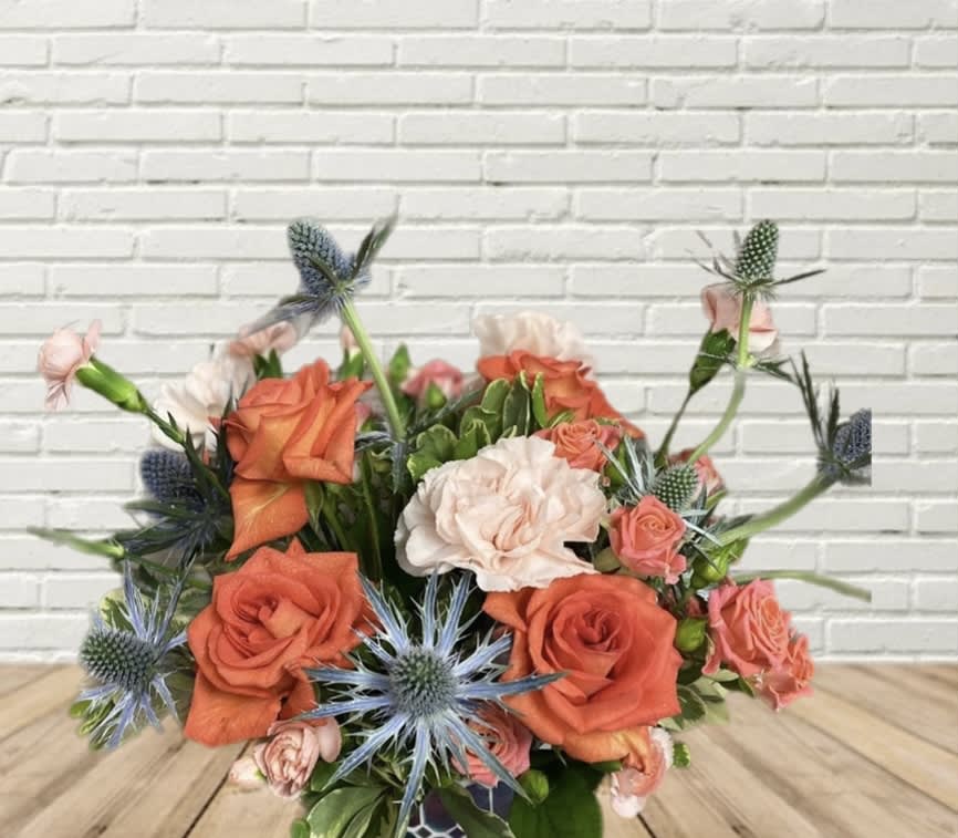 Icy Tangerine Icy Tangerine - Tangerine oranges, & Icy blue florals in this low & full arrangement.