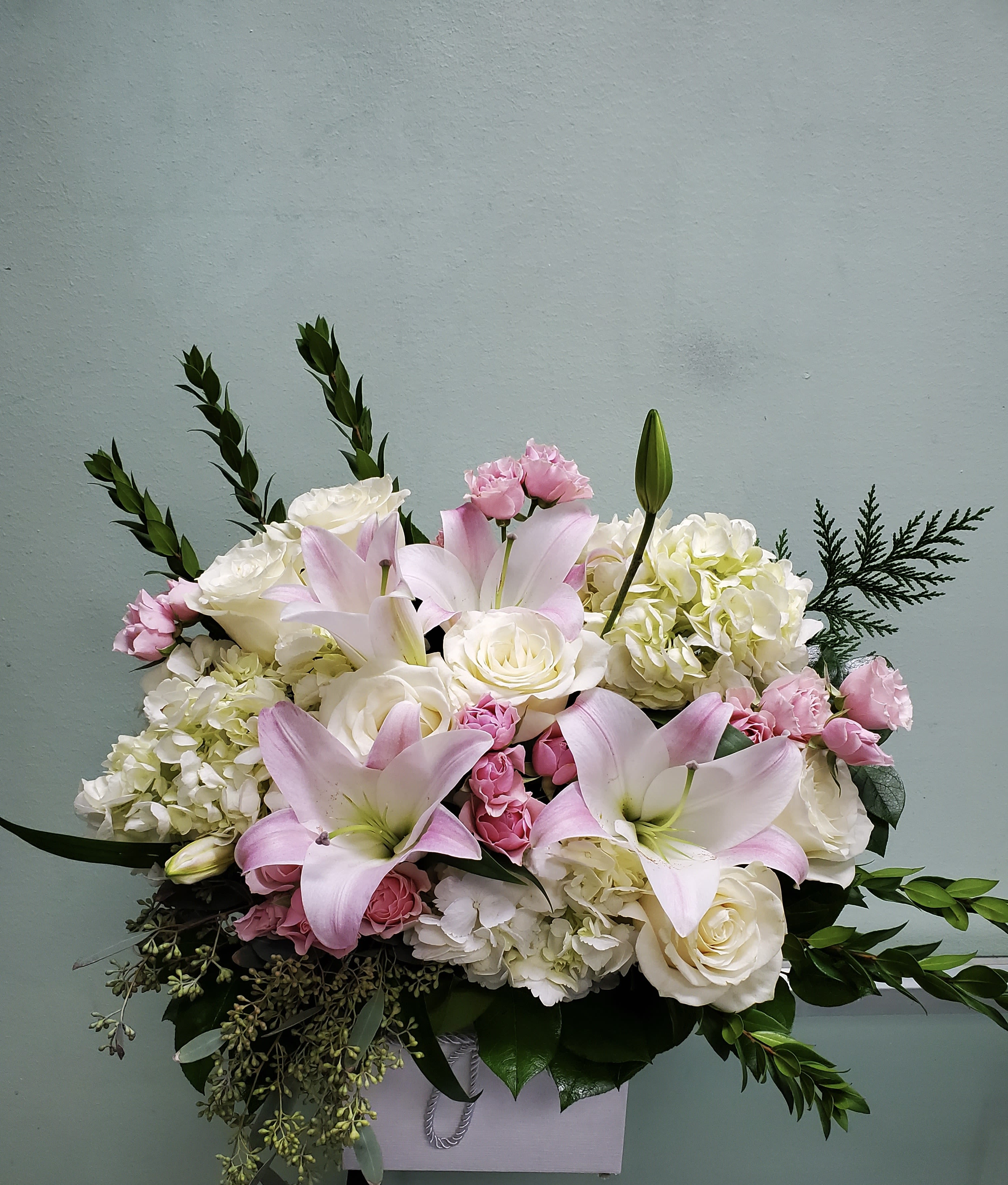 Burst of Light Burst of Light - Box arrangement with lilies, hydrangeas, roses, and spray roses.