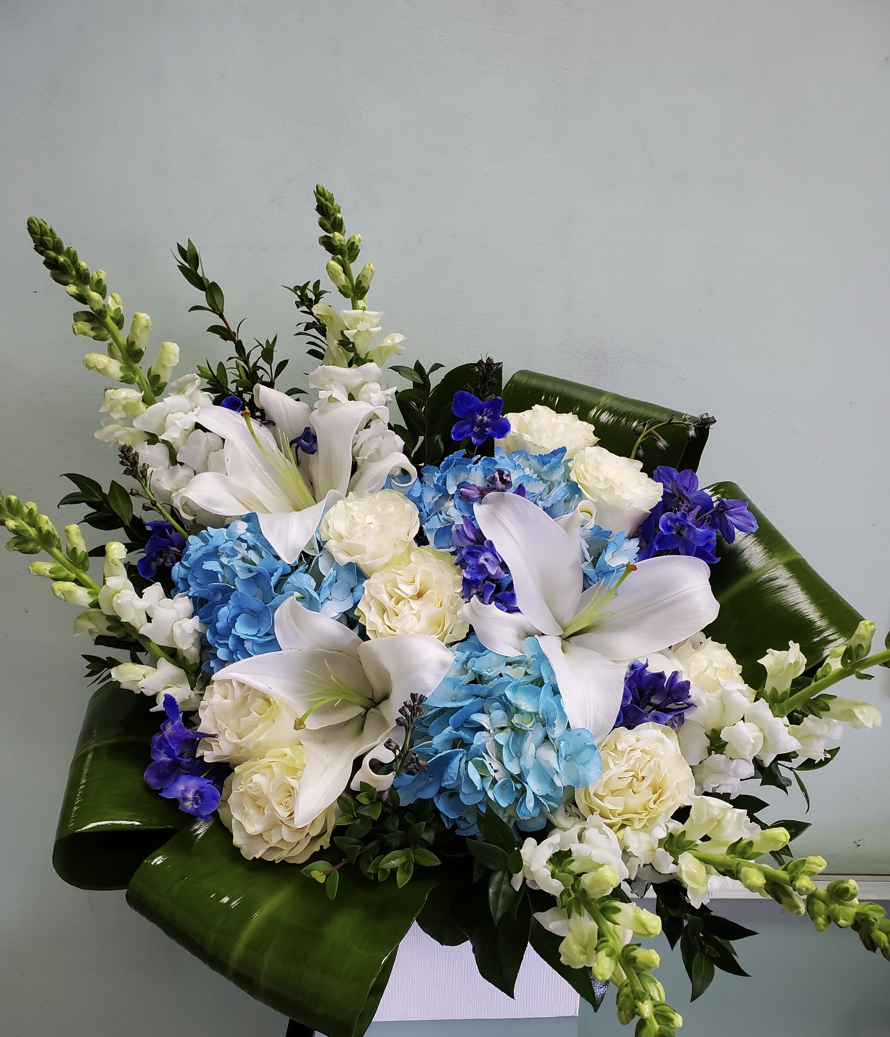Blue Fields Blue Fields - Box arrangement with lilies, hydrangeas, roses, delphiniums, and snapdragons.