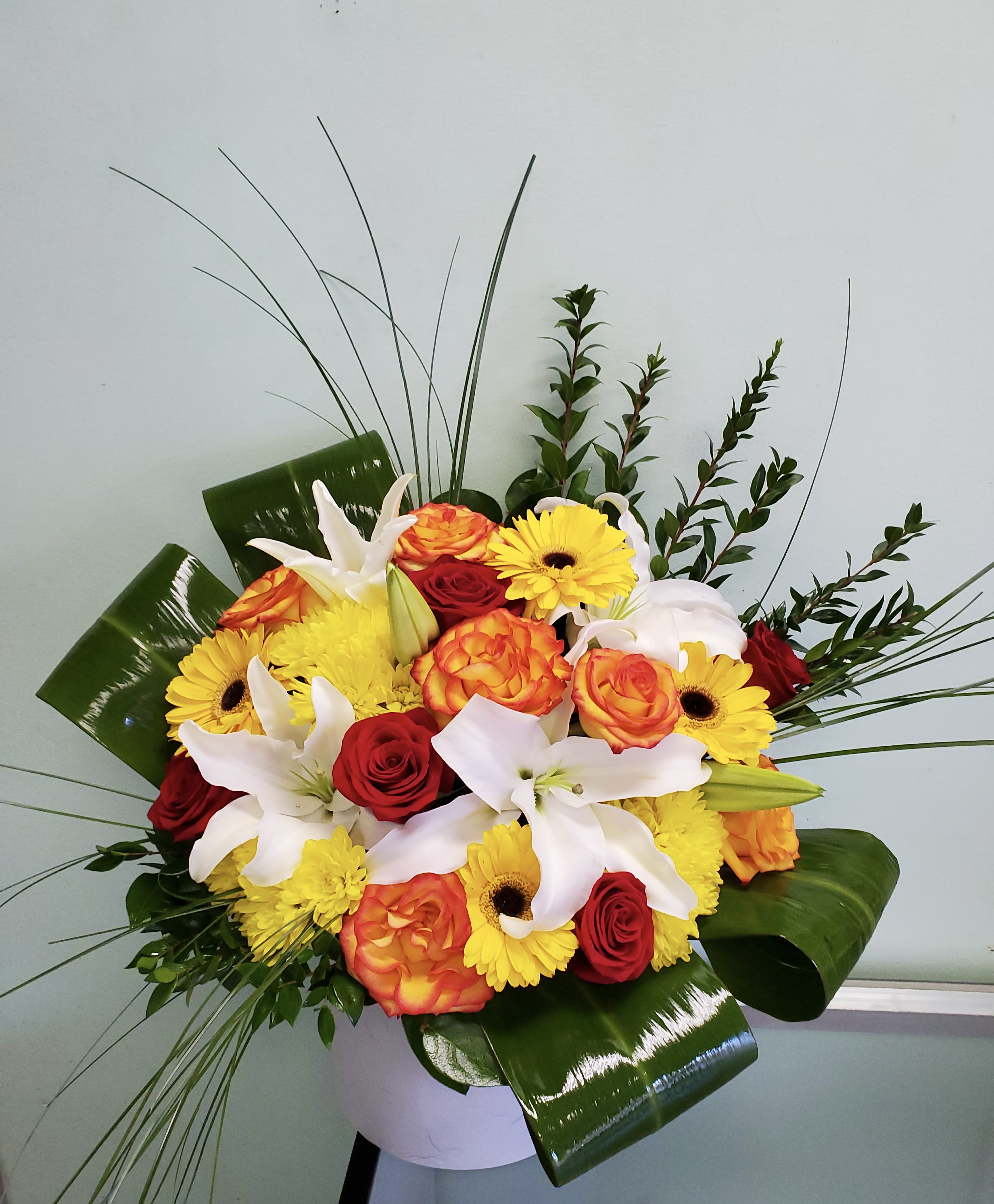 Sunny Splender  - Box arrangement with gerbera daisies, roses, cushion daisies, and lilies. 