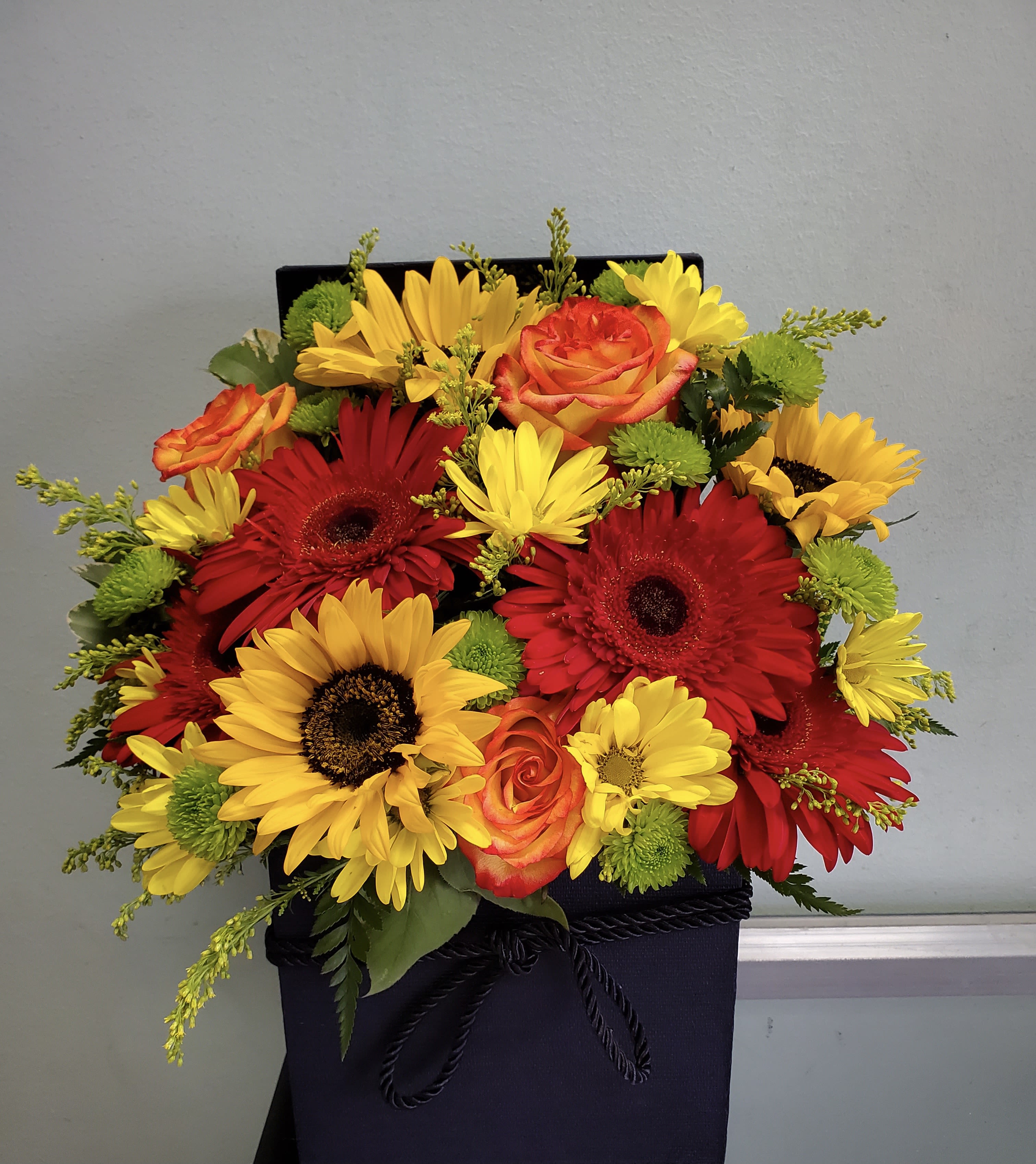 Summer Field Summer Field - Box arrangement with sunflowers, daisies, gerbera daisies, roses, and buttons.