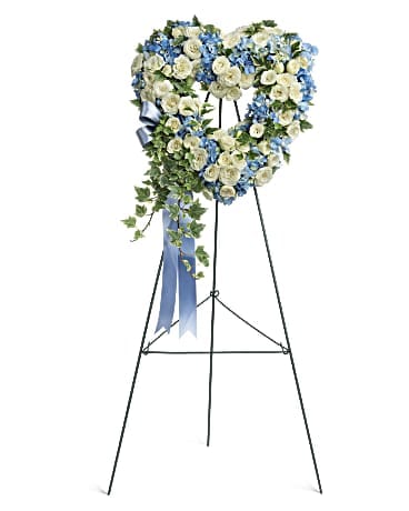 Pure Heart Pure Heart - Adorned with trailing ivy this sweet heart-shaped wreath of sky blue hydrangea and pure white roses is a loving remembrance. T283-7A