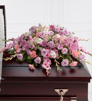 The Immorata Casket Spray The Immorata Casket Spray - The Immorata Casket Spray offers soft beauty and blushing comfort to honor the life of the deceased. Lavender roses, chrysanthemums, and parrot tulips are elegantly arranged amongst pink carnations, gladiolus, stock, hydrangea and lush greens to create a presentation, intended to bedeck the top of the casket, that evokes sweet memories of your loved one for their final farewell service.