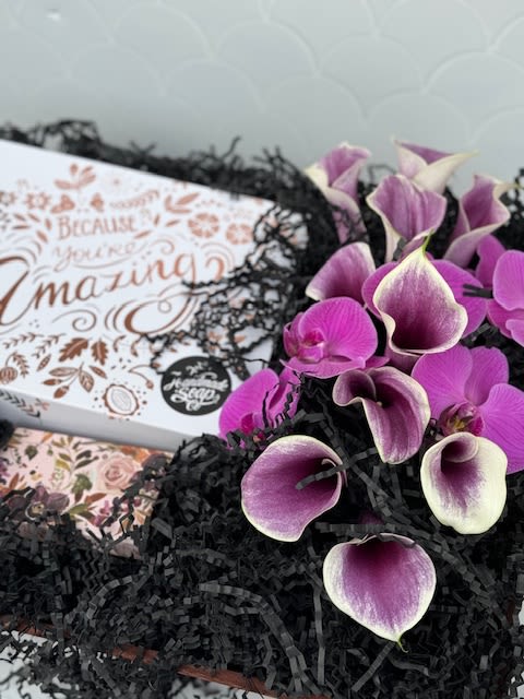 Simply Amazing Gift Box - A beautiful display in a wooden crate filled with purple florals, and our &quot;Your so Amazing&quot; gift package from 'The Handmade Soap' company. This gift package features full size body lotion, shower gel, and hand cream. All products from the 'The Handmade Soap' company are handmade in Ireland, all natural, Vegan friendly and Cruelty Free. It is the perfect gift for any occasion!