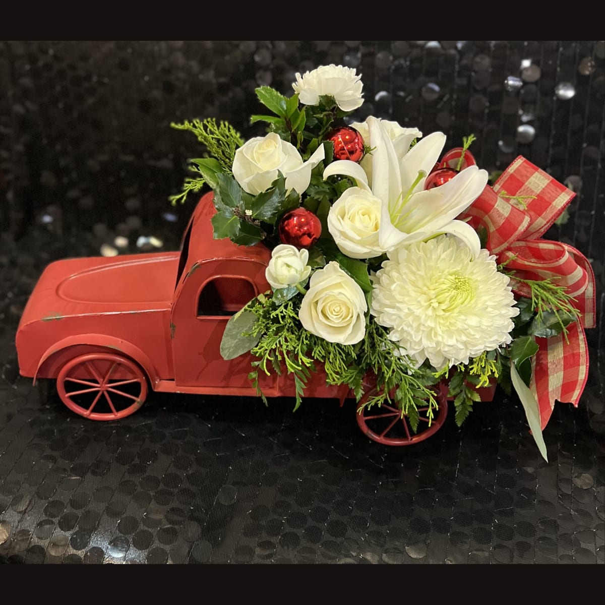 Home For Christmas - XM404  - In some instances, our photo may represent an overall theme or look and include a one-of-a-kind vase which cannot be exactly replicated.    Although the actual bouquet may not precisely match the photo, its temperament will. Occasionally, substitutions of flowers and/or containers happen due to weather, seasonality and market conditions which may affect availability. If this is the case with the gift you’ve selected, we will ensure that the style, theme and color scheme of your arrangement is preserved and will only substitute items of equal value or higher value.    If any design elements are of major importance to your order, please include them in the florist instructions at checkout or contact us to ensure availability. 