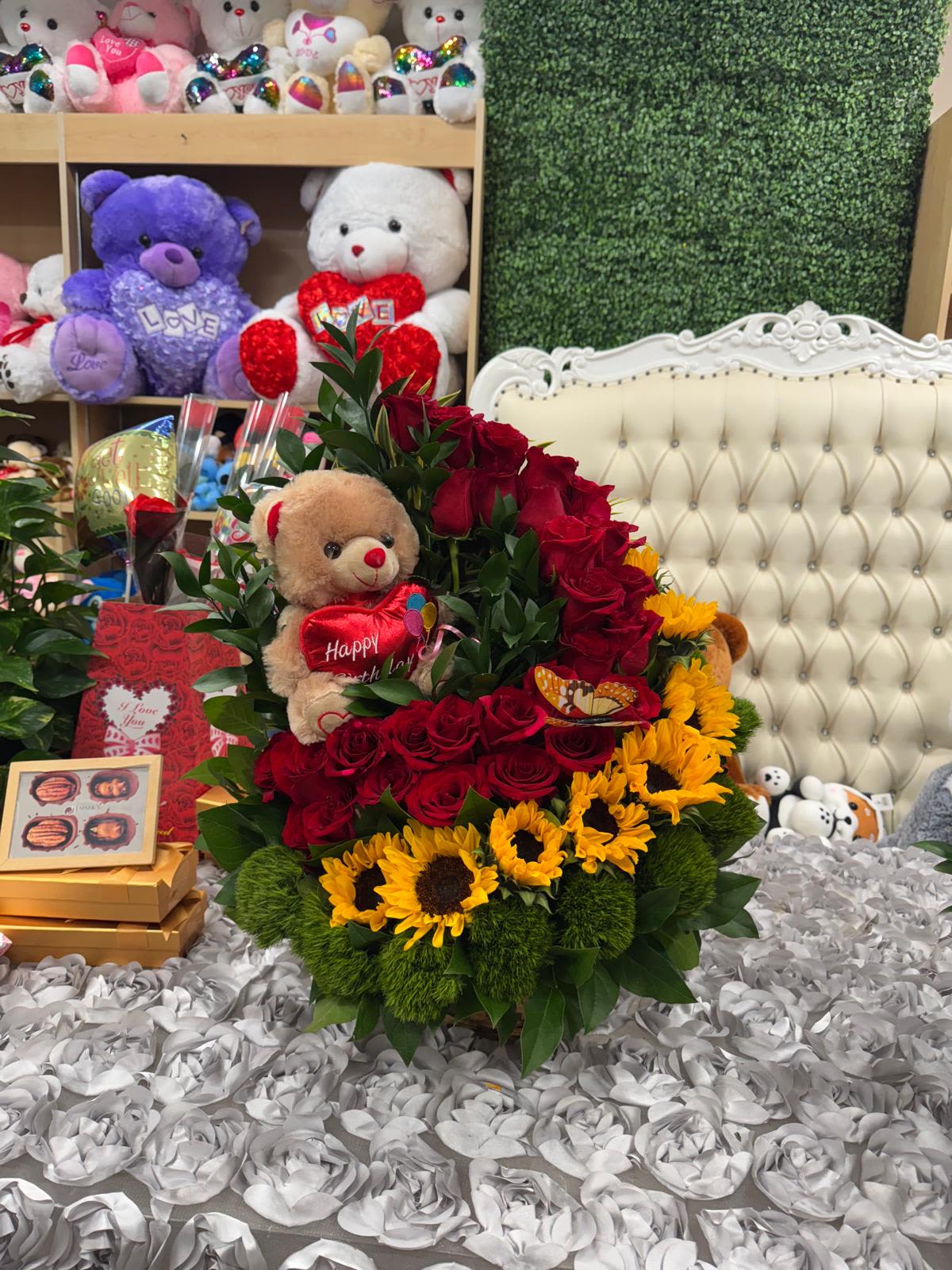 Sunflower Path Sunflower Path - arrangement of roses with sunflowers and a sweet stuffed animal, surrounded by green foliage.