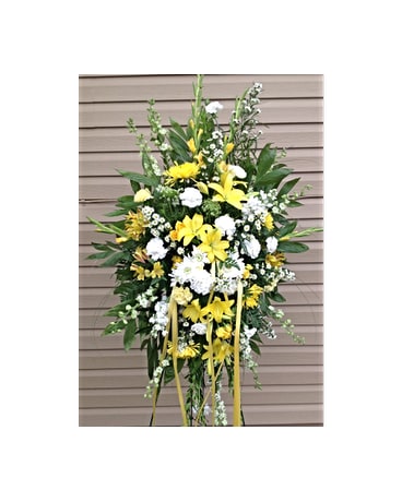 Peaceful Passage Spray Peaceful Passage Spray - This hand arranged standing spray includes yellow Lillies white and yellow Carnations yellow Fugi Mums white Stock white Larksburg Monte Casinoa and yellow Alstroemeria. All flowers and colors are subject to change due to availability. FCF-0311