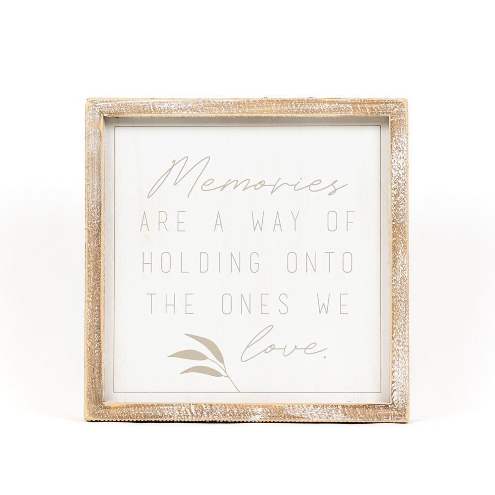 Memories Wood Sign - Capture the essence of cherished memories with our elegantly crafted wood-framed sign. Measuring 10.25x10.25x1.5 inches, this heartfelt piece features the touching inscription, “MEMORIES ARE A WAY OF HOLDING ONTO THE ONES WE LOVE.” Its rustic design and soothing message make it a perfect addition to any space, offering comfort and remembrance during times of reflection. Ideal for memorials, sympathy gifts, or as a gentle reminder of the bonds we hold dear, this sign beautifully complements your floral arrangements, providing a lasting tribute to loved ones.   Note: Standard size includes sign only. Deluxe and Premium sizes include the sign in a floral arrangement with colors and blooms appropriate for the season.