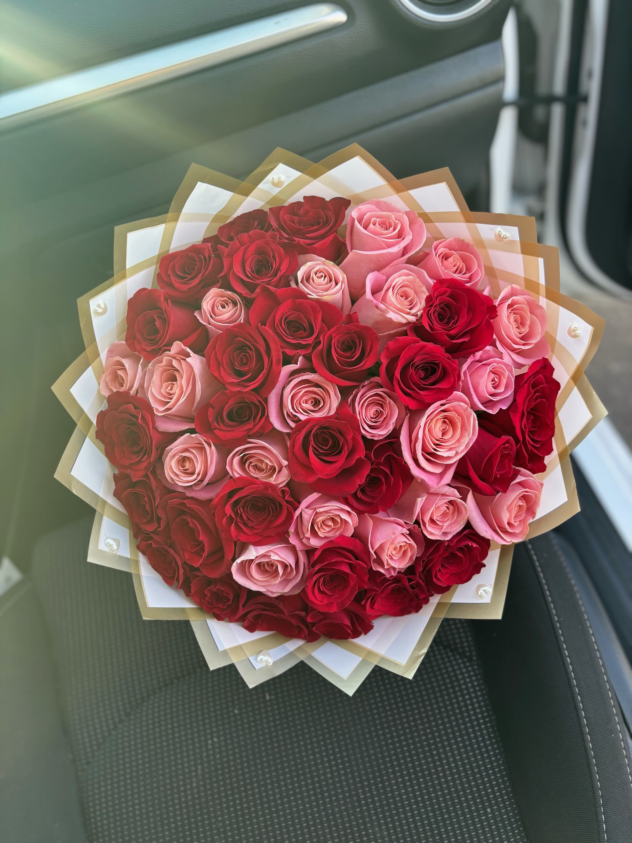 Pearl Hearts Bouquet  - 50 Red and Pink roses wrapped in a soft pink wrap with pearl heart accessories.  A perfect effortless way to let someone know they are special. 