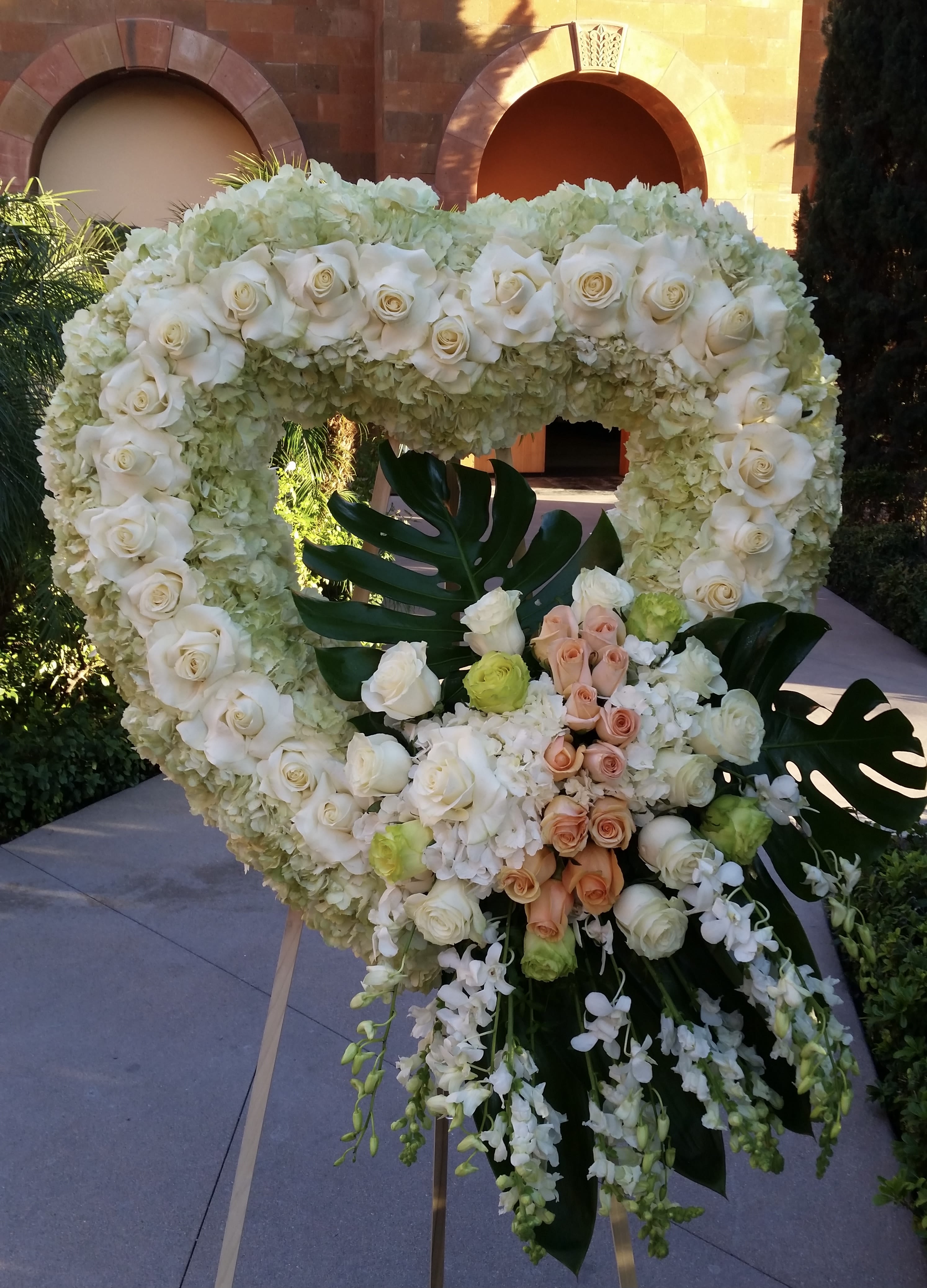 Peaceful Rest  - Open heart with white hydrangeas, white roses, peach roses, green roses, and white orchids.