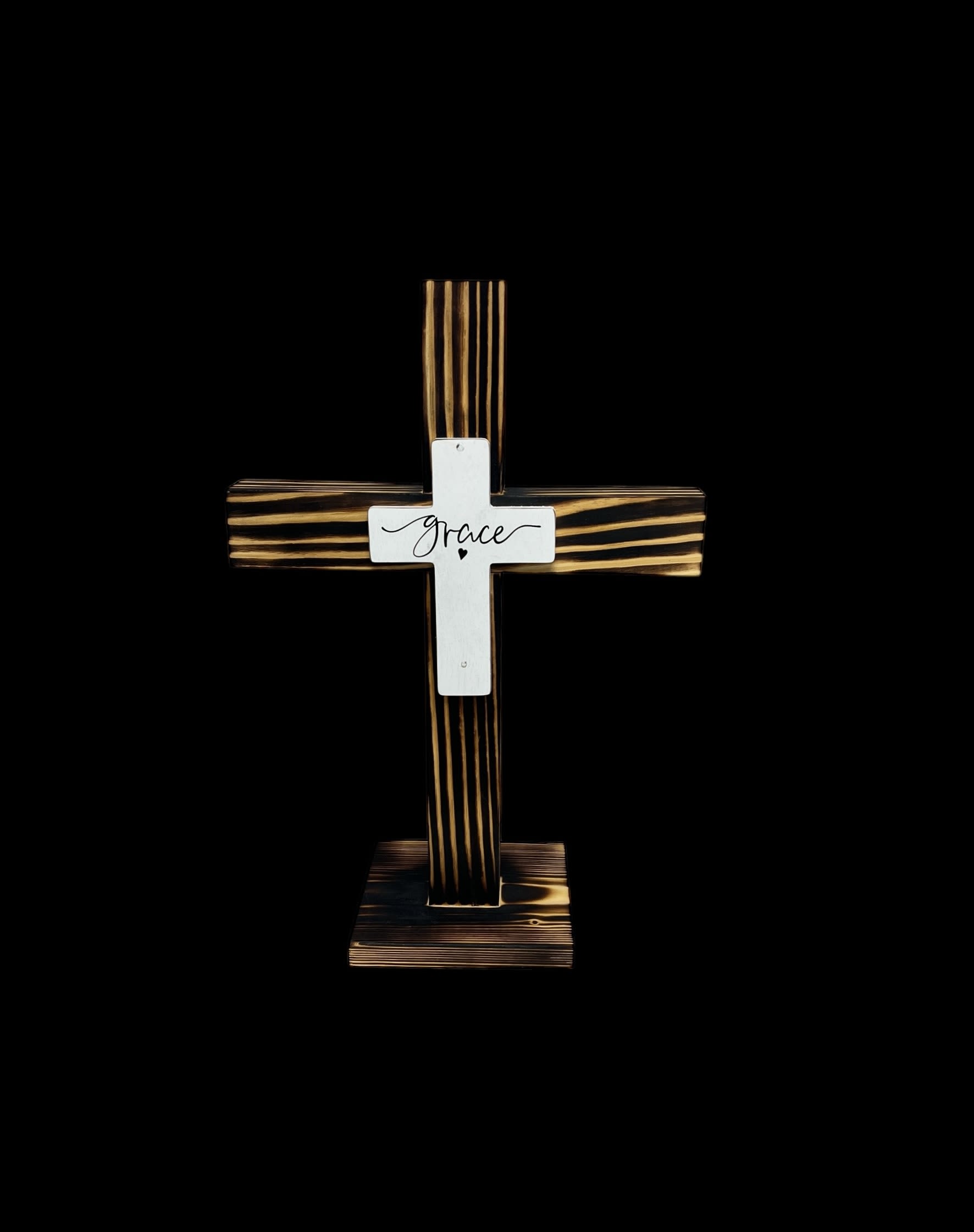Eternal Grace Cross -   Celebrate faith and honor the memory of loved ones with the Eternal Grace Cross. Crafted from beautifully stained wood with striking, rustic details, this cross serves as a timeless symbol of peace, hope, and grace. The central metal plate, engraved with the word “Grace,” adds a meaningful touch, making it perfect for memorials, gifts, or as a decorative piece in your home. &quot;17'12  