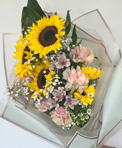 Sunny Wrapped Bouquet - A gorgeous combination of sunflowers, daisies, and roses.