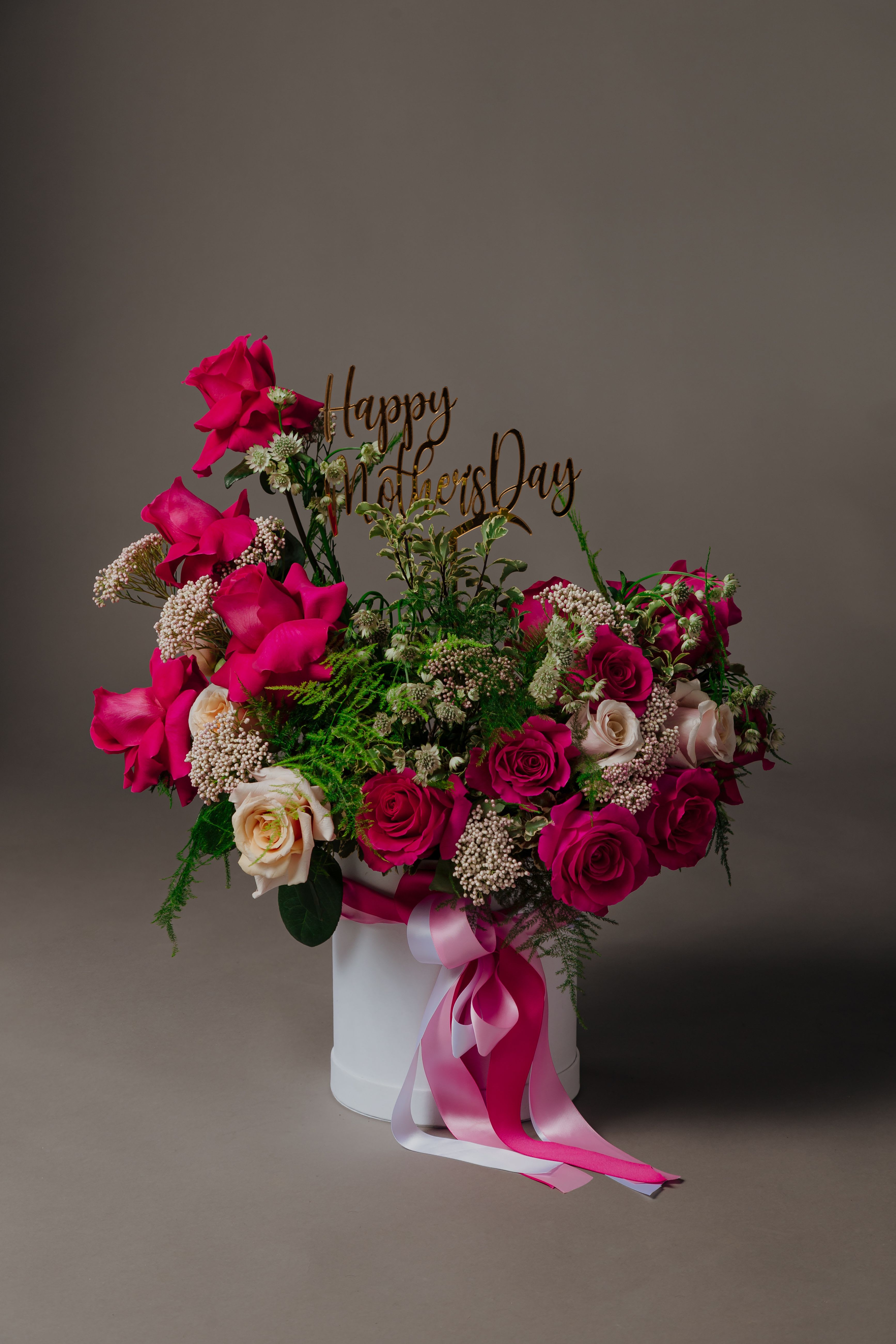 Vibrant Fuchsia Roses Arrangement – Stunning Floral Design for Special Occasions - Introducing the &quot;Vibrant Fuchsia Amazing Roses Arrangement&quot; from Flora by Cortez – a spectacular floral masterpiece designed to enchant and delight.  Radiating with the bold and captivating beauty of vibrant fuchsia roses, this arrangement is a true celebration of elegance and charm. Each rose is meticulously selected for its exceptional quality and rich hue, creating a stunning visual display that is sure to captivate all who behold it.  Set against a backdrop of lush greenery, the &quot;Vibrant Fuchsia Amazing Roses Arrangement&quot; exudes an air of sophistication and luxury, making it the perfect centerpiece for any occasion. Whether adorning a dining table, brightening up a living space, or serving as a thoughtful gift for a loved one, this arrangement is guaranteed to leave a lasting impression.  Indulge in the extraordinary with the &quot;Vibrant Fuchsia Amazing Roses Arrangement&quot; from Flora by Cortez. Elevate your surroundings with the unparalleled beauty of fuchsia roses and make every moment truly unforgettable.