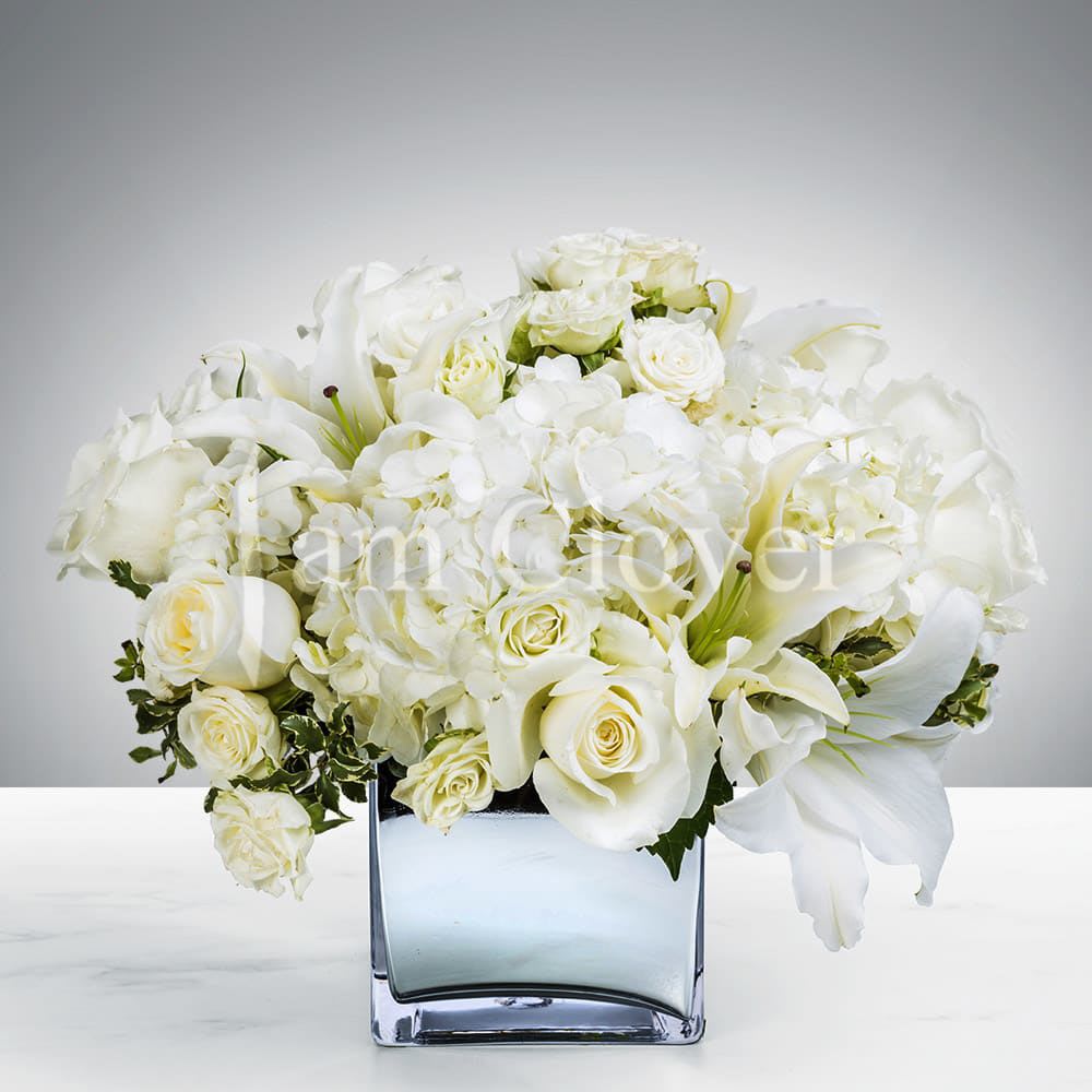 Snowball - Bringing the spirit and cool tones of the snowy season!  Fulfill your floral needs at I Am Clover in Ramona, CA, and experience the difference in quality, freshness, and care that comes with ordering locally.   Disclosure: In some instances, our photo may represent an overall look and include a one-of-a-kind vase which cannot be exactly replicated. Occasional substitutions of flowers and/or containers happen due to weather, seasonality and market conditions. We will ensure that the style, theme and color scheme of your arrangement is preserved and will only substitute items of equal value or higher value.  Delivery: 2:30pm - 6:30pm Same Day Orders may take at least 6 hours to process and deliver Morning and Specific Delivery Time Requests:  will be charged a $15 convenience fee. Specific delivery times are acknowledged and we will do our best to accommodate, however we cannot guarantee on time delivery due to unforeseen events.  Gate Codes are mandatory for our delivery drivers to enter residential or commercial buildings. If you don’t know the gate code for a delivery, please contact the recipient and provide us with it or our driver can contact the recipient before beginning a delivery route to obtain the code. Our policy states that drivers will only wait five minutes outside the gate for a callback. If a driver has to leave a property, the delivery is reassigned for the next day and may charge an additional delivery fee.   Thank you!