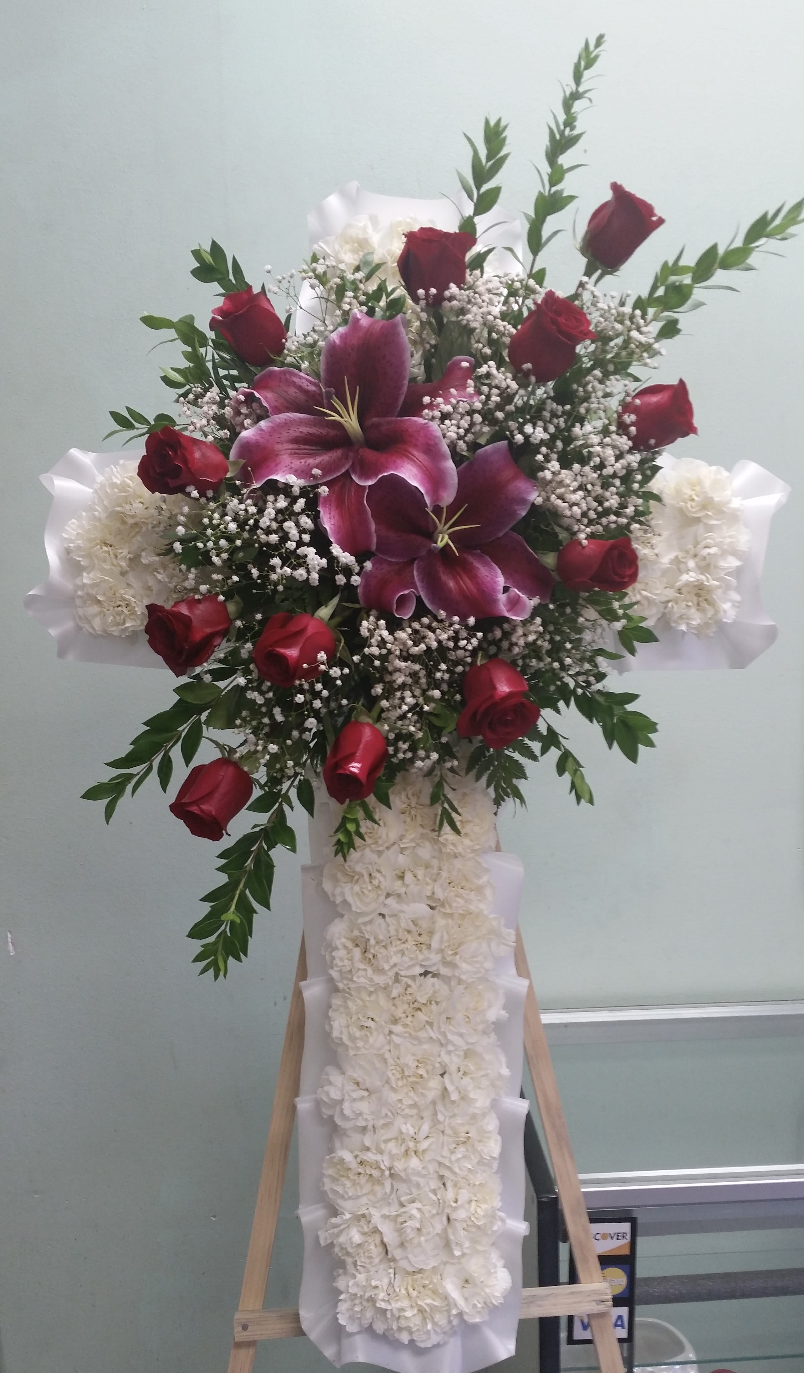 Forever Cross Forever Cross - Cross with red roses, white carnations, and lilies.
