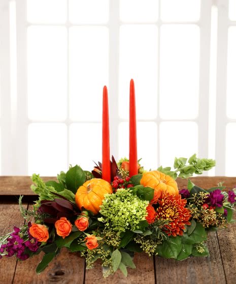 Autumn Traditions Table Centerpiece - Thanksgiving centerpiece with tapered candles featuring rich fall colors including roses, chrysanthemums, stock, berries and lush foliage.