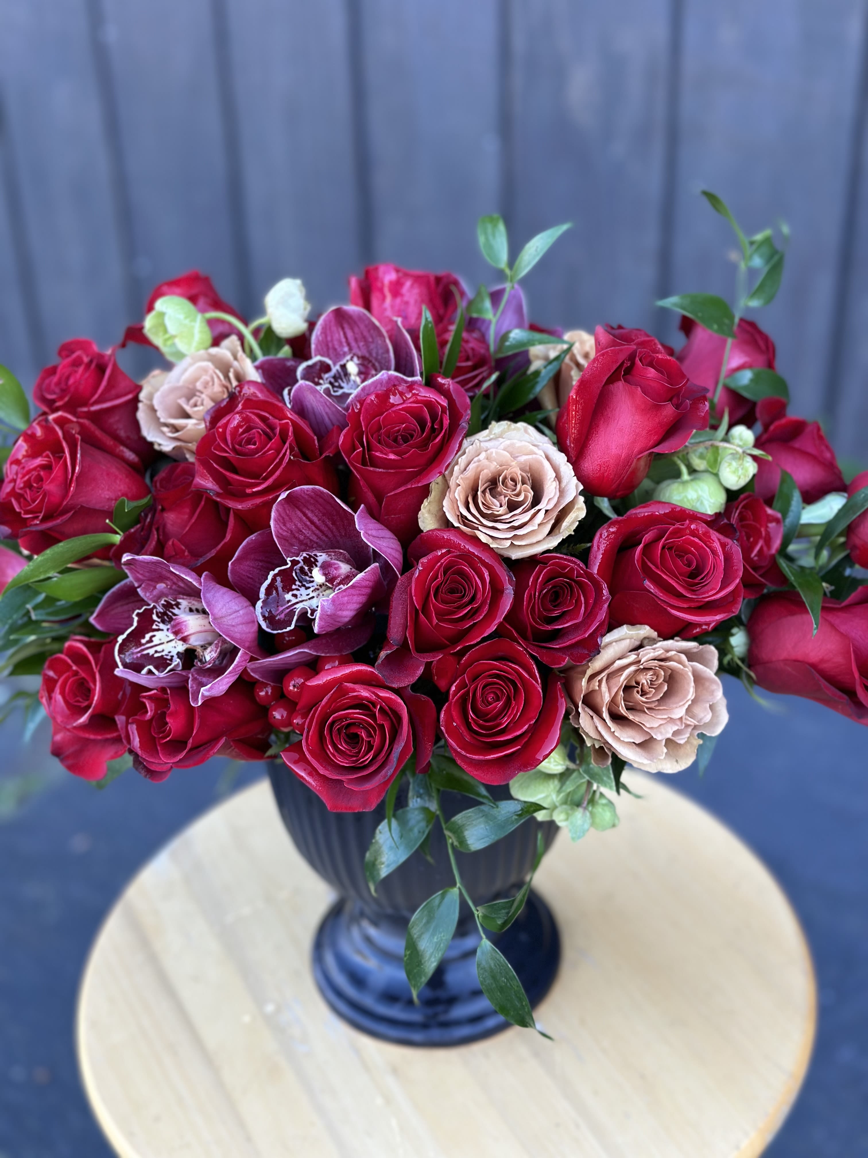 Victoria’s Secret  - A smashing statement piece… Filled with orchids. and a minimum 3 doz roses (5 dozen for premium)…. Containers may vary upon availability 