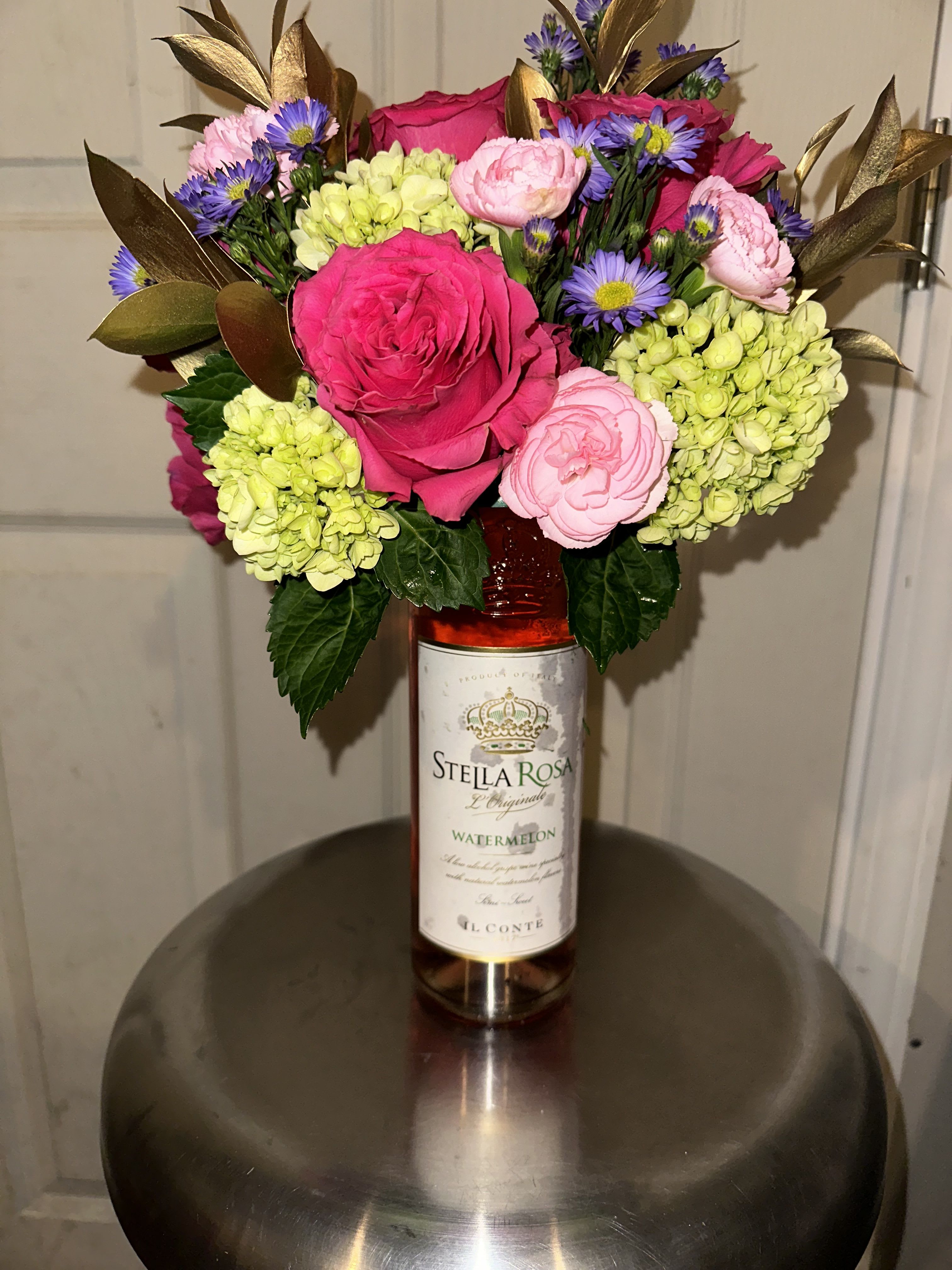 flowers on the wine - botte wine with mixes flowers such as hydrangeas, roses, monte casino and  mini carnation