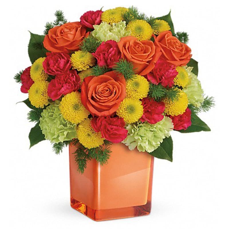 Citrus Smiles Bouquet [TEV43-3A] - They brighten your days with their friendship and love, brighten theirs with these bold and beautiful blooms! Hand-delivered in a stylish glass cube, a gift in and of itself - this spirited mix of roses, carnations and mums is sure to make them smile!  Bold orange roses, green carnations, dark pink miniature carnations, and yellow button spray chrysanthemums are mixed with ming fern and lemon leaf. Delivered in a glass cube.  Approximately 11 1/2&quot; W x 11 3/4&quot; H  Orientation: One-Sided      As Shown : TEV43-3A