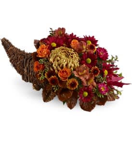 Plentiful Petals Cornucopia [TFWEB450] - For a unique and festive fall display, choose this rustic autumn cornucopia that's bursting with a medley of fresh flowers in subtle tones of bronze, red and orange. It's a charming Thanksgiving display for your dining table, buffet table or sideboard.  A mix of fresh flowers such as chrysanthemums, Matsumoto asters, spray roses and alstroemeria in shades of bronze, red and orange - with accents such as huckleberry, seeded eucalyptus, salal and preserved beech - is arranged in a 10&quot; cornucopia.  Approximately 7&quot; (W) x 19&quot; (H)  Orientation: All-Around      As Shown : TFWEB450  