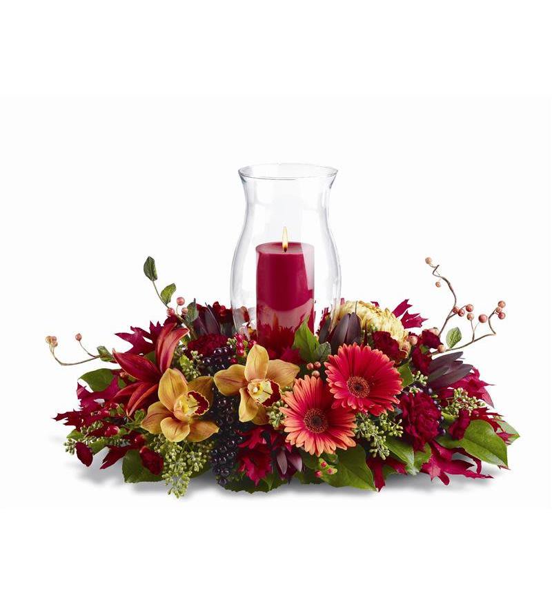 Harvest Hurricane - Hurricane centerpieces are a holiday tradition; and this harvest-themed display - with its mix of orchids, Asiatic lilies and gerberas in fall colors of orange, burgundy, red and bronze - is just right for the holiday table, or to decorate your home this season.