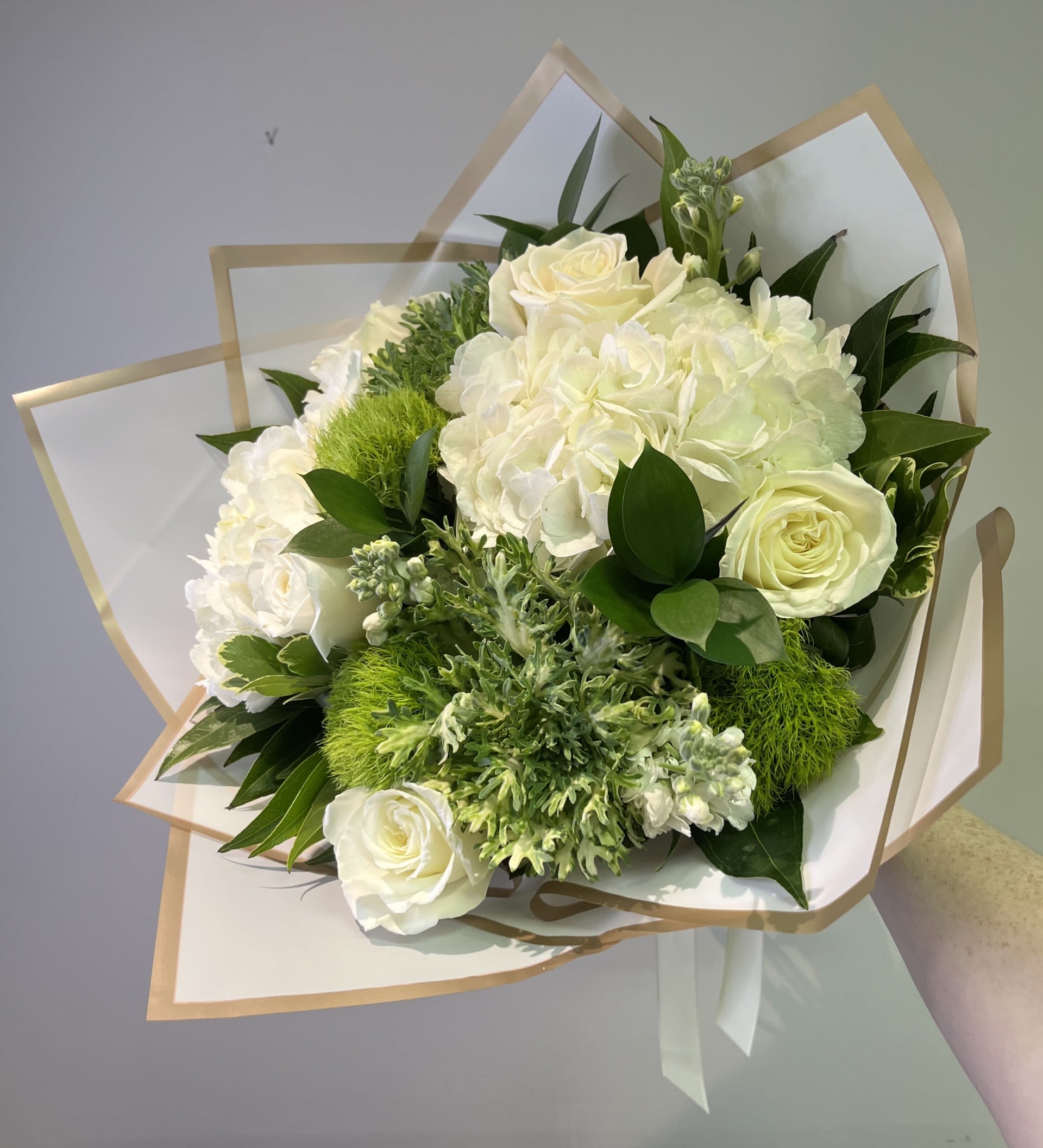 Ivory Elegance Handtied by Chasing Petals - A beautiful handtied bouquet of white and green flowers, sure to wow the modern, monochromatic lover in your life.