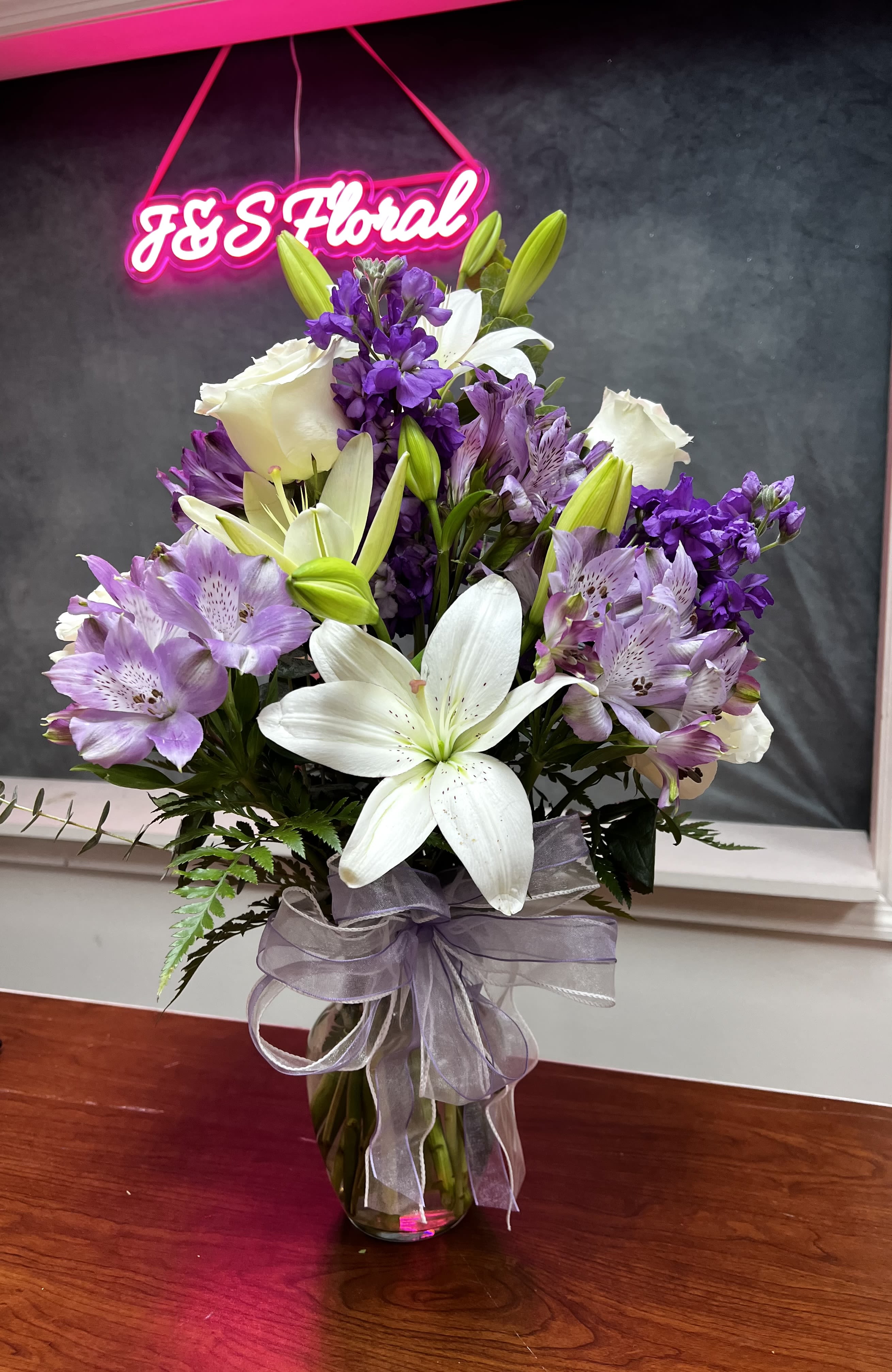 White and Purple Elegance White and Purple Elegance - Our White and Purple Elegance Vase showcases a harmonious mix of pristine white blooms and rich purple accents. This stunning arrangement exudes grace and sophistication, perfect for brightening any space or celebrating life's special moments with timeless beauty.
