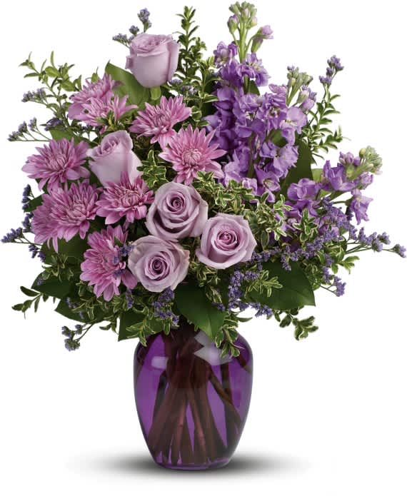 TOGETHER AT TWILIGHT BOUQUET TOGETHER AT TWILIGHT BOUQUET - The perfect pick for the purple lover in your life! This impressive bouquet charms with roses, stock and mums. Presented in a gorgeous glass vase. This dramatic arrangement includes lavender roses, lavender stock, lavender cushion spray chrysanthemums, lavender limonium, oregonia and lemon leaf.
