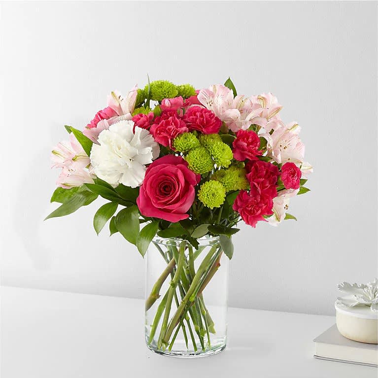 Sweet &amp; Pretty Bouquet - The true beauty of this bouquet is within the sweet colors of the flowers. An array of hot pink roses, pale pink alstroemeria and more are set in a glass cylinder vase, making a wonderful gift to light up the face of its recipient.  Please Note: The bouquet pictured reflects our original design for this product. While we always try to follow the color palette, we may replace stems to deliver the freshest bouquet possible, and we may sometimes need to use a different vase.