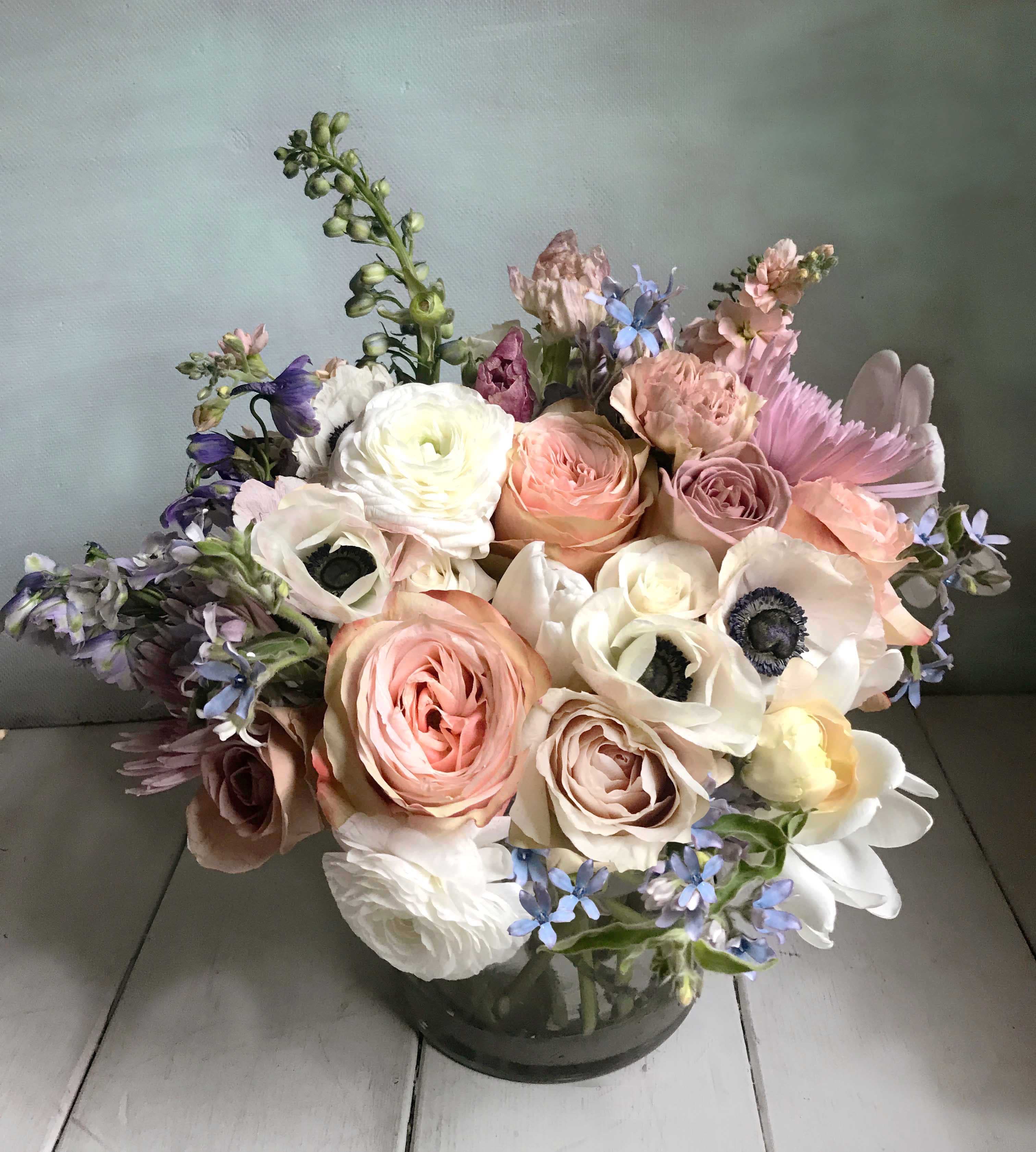 Tara Arrangement - Elegant arrangement of gorgeous dusty golden, sandy, coral colors. Arranged in a 5&quot; by 5&quot; clear cylinder vase. Measures appx 12&quot; by 10&quot;. Chose the Deluxe for a larger arrangement, arranged in a 6&quot; by 6&quot; clear cylinder vase, measurements appx 13&quot; by 11&quot; or the Premium size for a larger arrangement, arranged in a 6&quot; by 6&quot; clear cylinder vase, measurements appx 14&quot; by 12&quot;. Roses, anemones, and seasonal flowers and light greens adorn this classic arrangement. Blomst LA only uses fresh, high quality flowers, all carefully selected every day to fit your flower order. We offer a personal hand delivery by our own delivery staff and guarantee the flowers will look perfect, when they arrive. We deliver in Glendale, Pasadena, Eagle Rock, Hollywood, Burbank, Beverly Hills - and everywhere else in Greater Los Angeles.