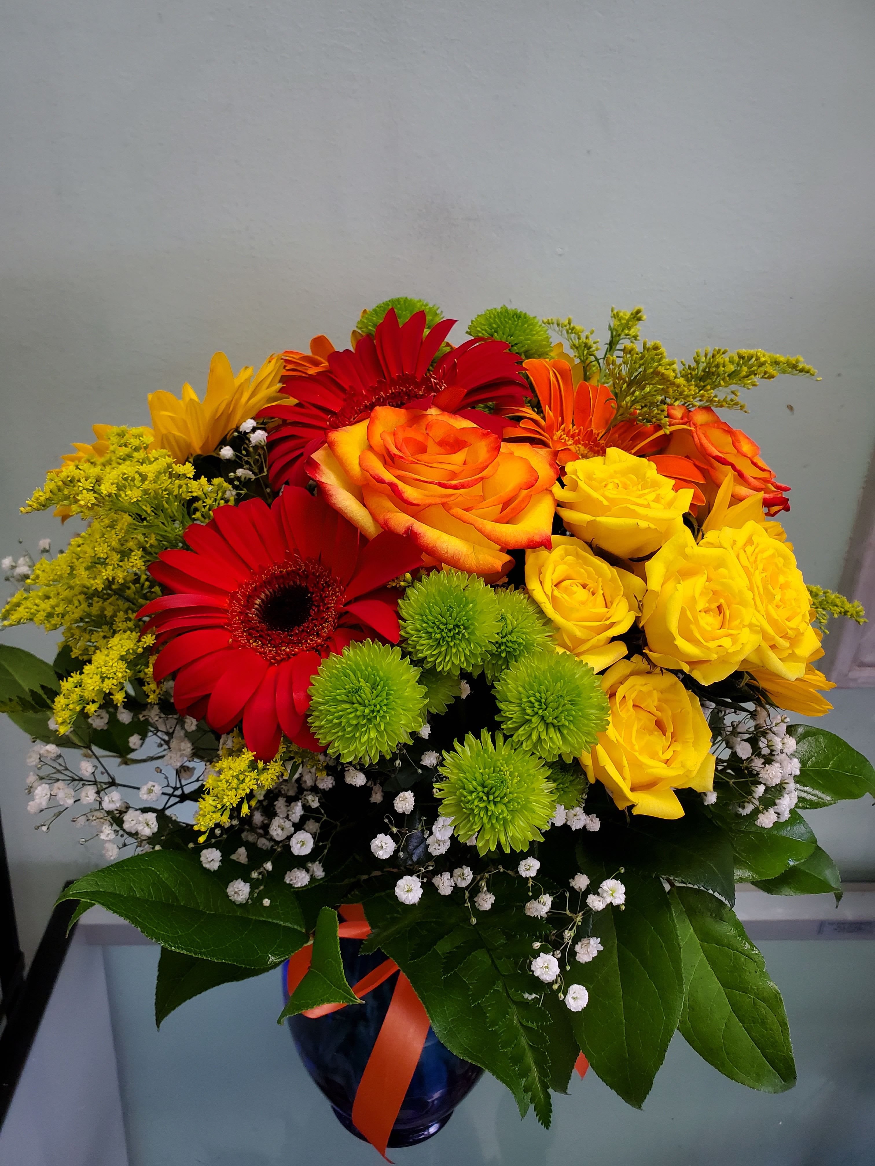 Cheer Up Cheer Up - Vase arrangement with gerbera daisies, roses, spray roses, and button daisies.