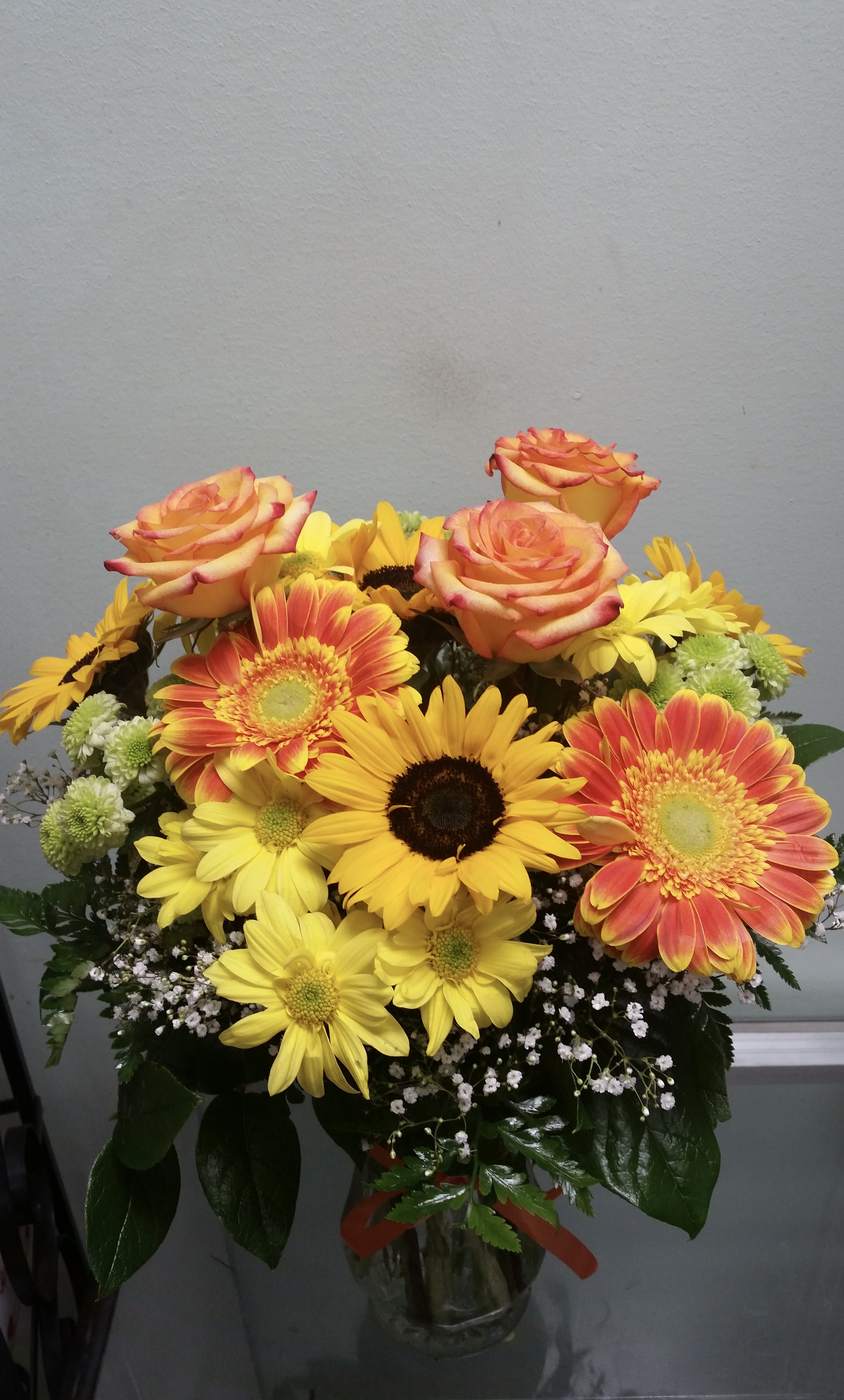 Sunshine Splash  - Vase arrangement with daisies, sunflowers, roses, and button daisies.
