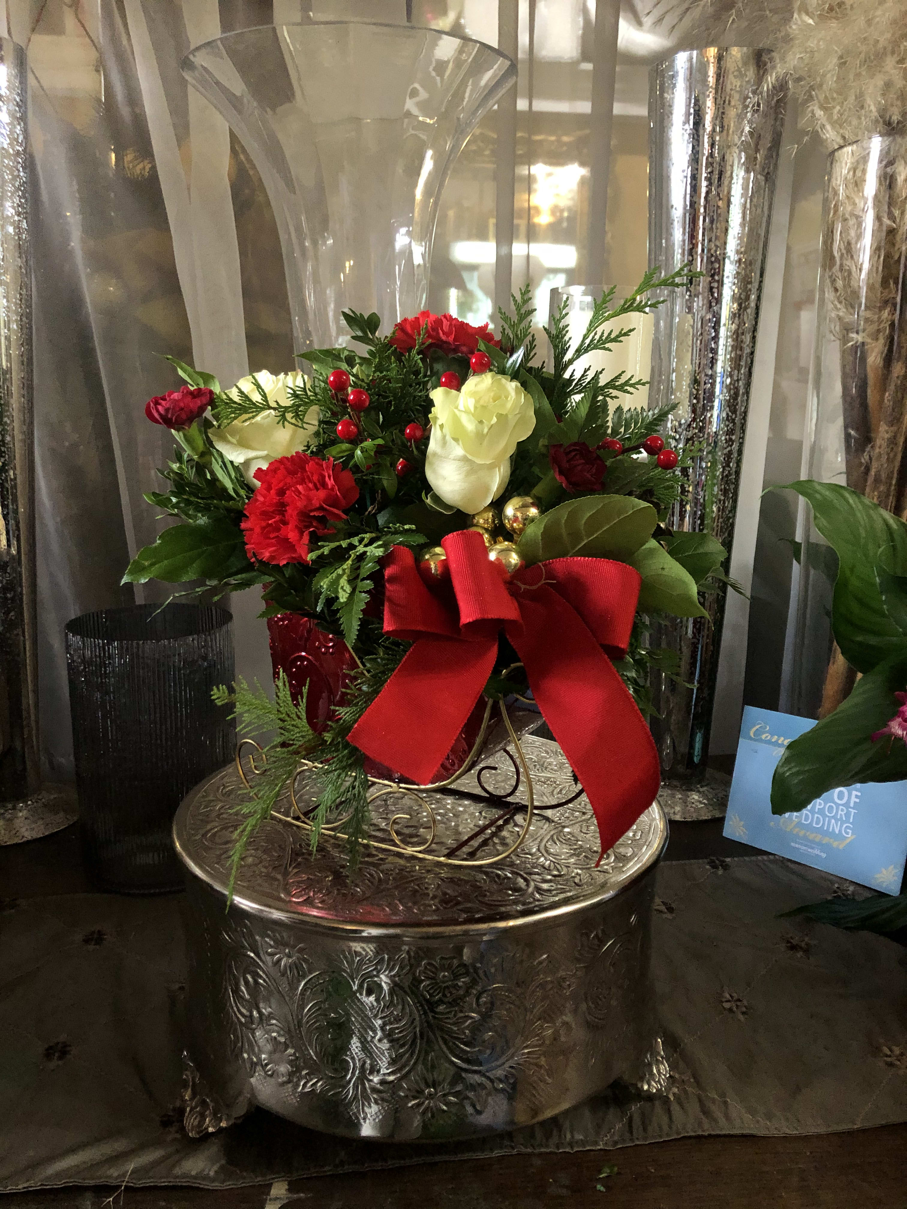Holiday Sleigh XM0391 - This sleigh arrangement is a perfect addition to the home Christmas decor. Topped with berries, bulbs, and a bow this small piece will look beautiful in the home.    Shown in Deluxe  Holiday Sleigh XM0391